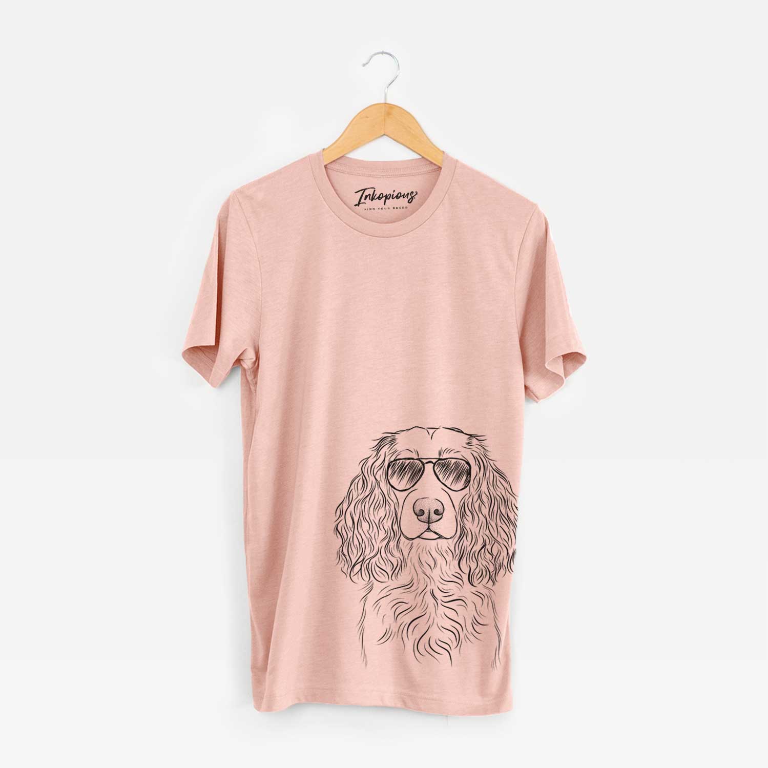 Hand-drawn sketch of Landry the Boykin Spaniel wearing aviator sunglasses on a Peach Bella Canvas Unisex Crewneck