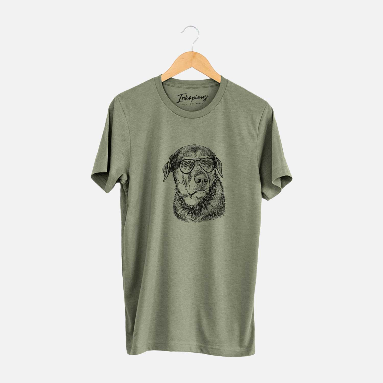 Hand-drawn sketch of Lobo the Shepherd Mix wearing aviator sunglasses on an Olive Unisex crewneck