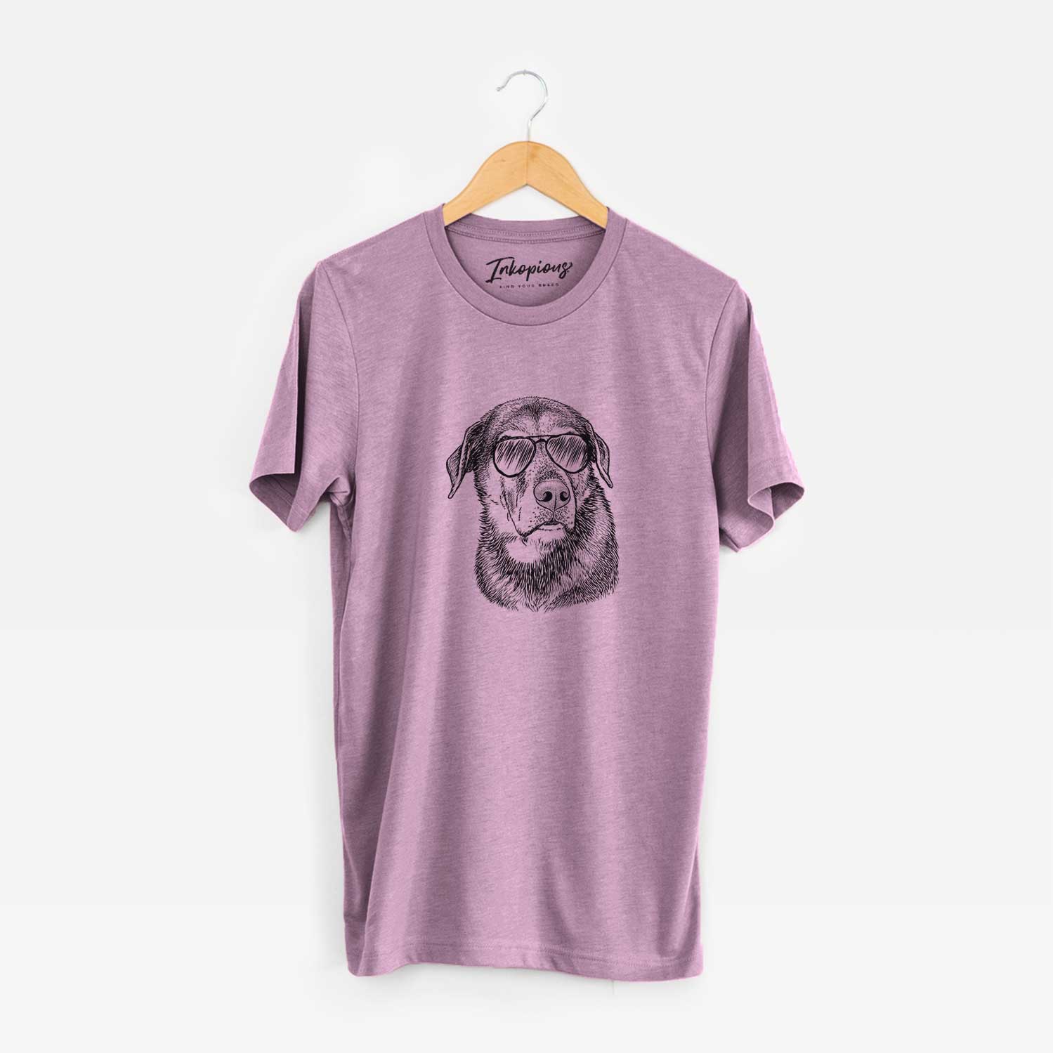 Hand-drawn sketch of Lobo the Shepherd Mix wearing aviator sunglasses on an Orchid Unisex crewneck