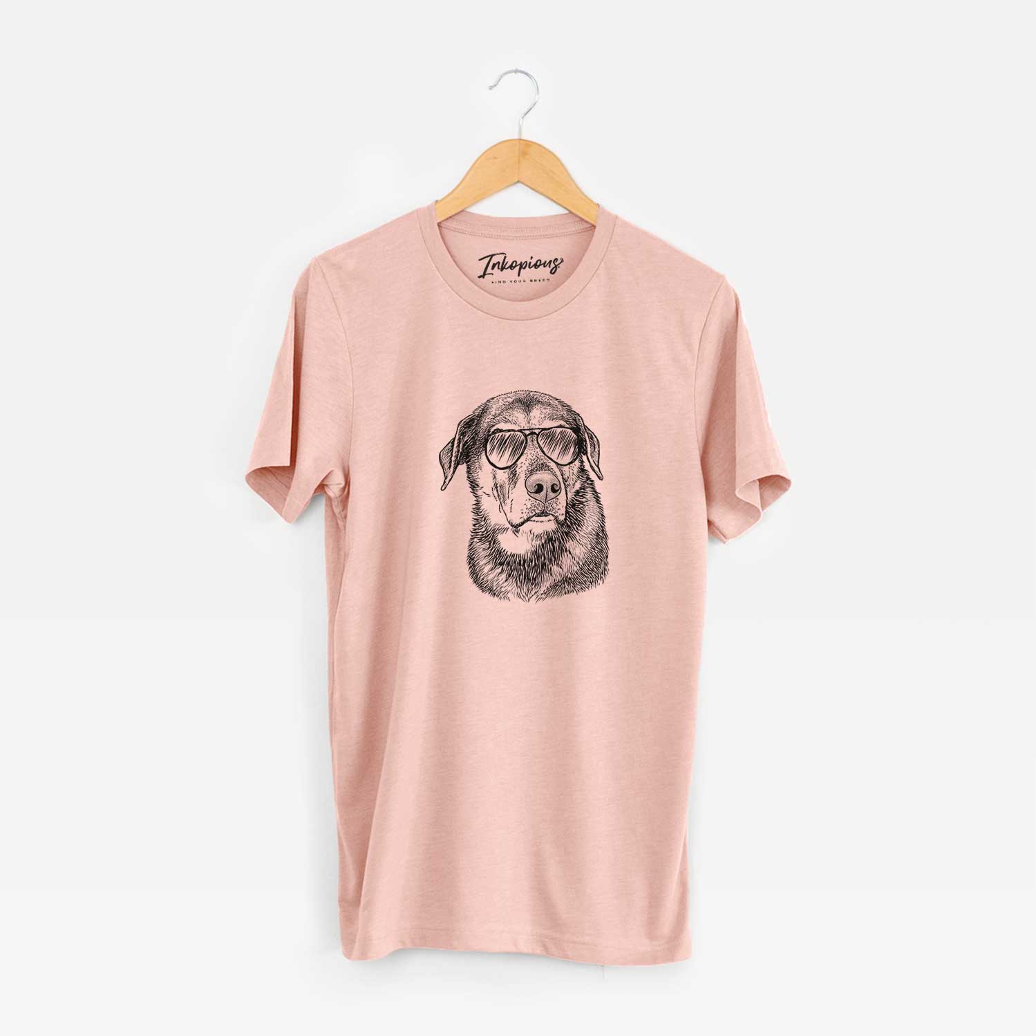 Hand-drawn sketch of Lobo the Shepherd Mix wearing aviator sunglasses on a Peach Unisex crewneck