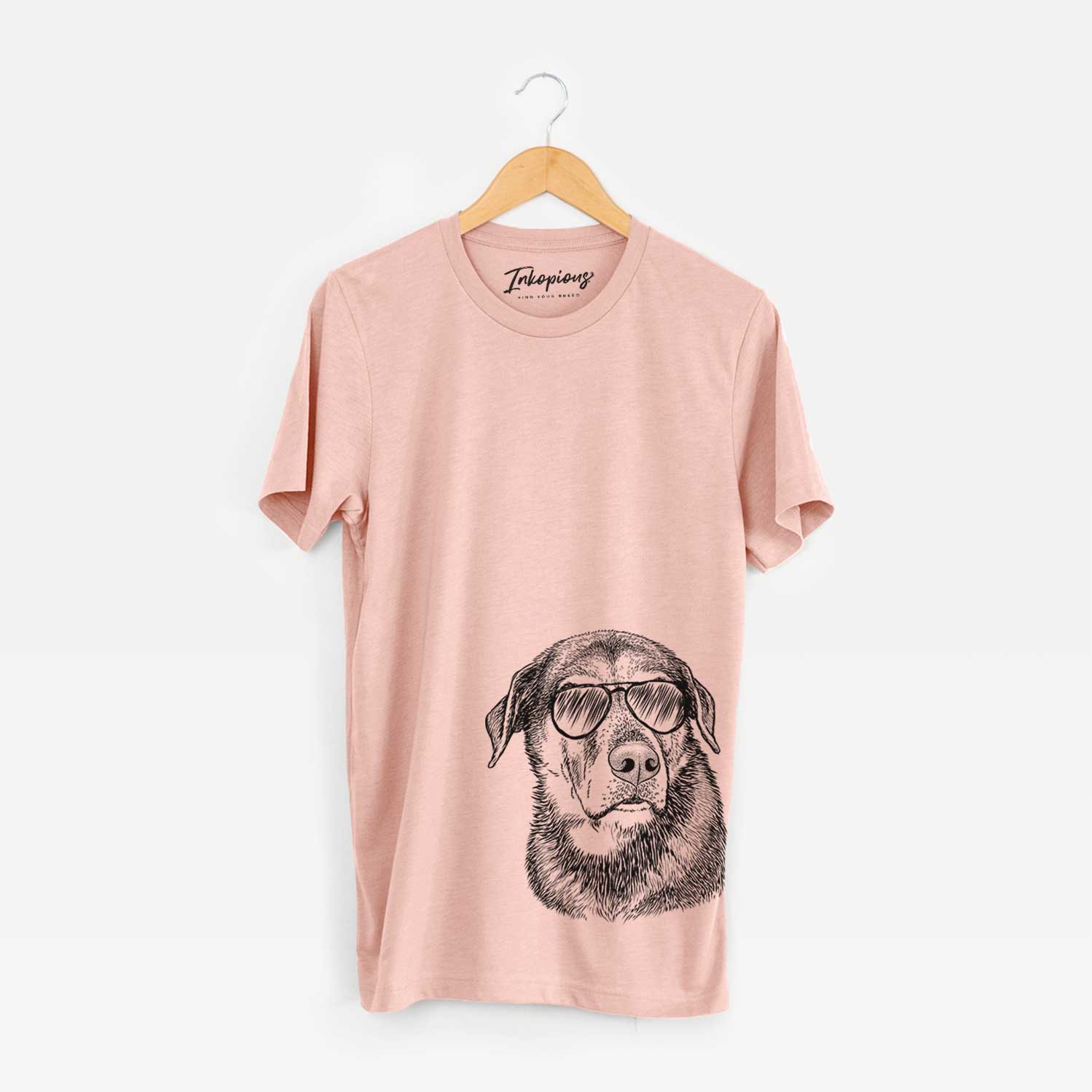 Hand-drawn sketch of Lobo the Shepherd Mix wearing aviator sunglasses on a Peach Unisex crewneck