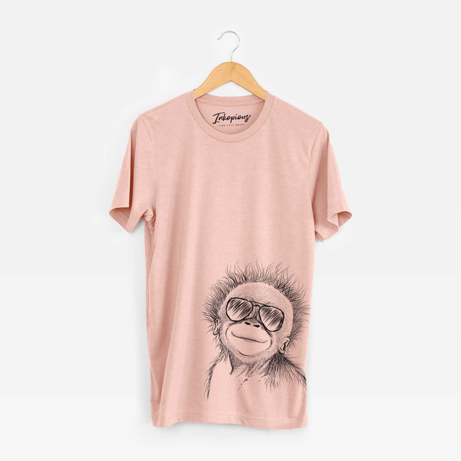 Hand-drawn sketch of Louie the Baby Orangutan wearing aviator sunglasses on a Peach Bella Canvas Unisex Crewneck