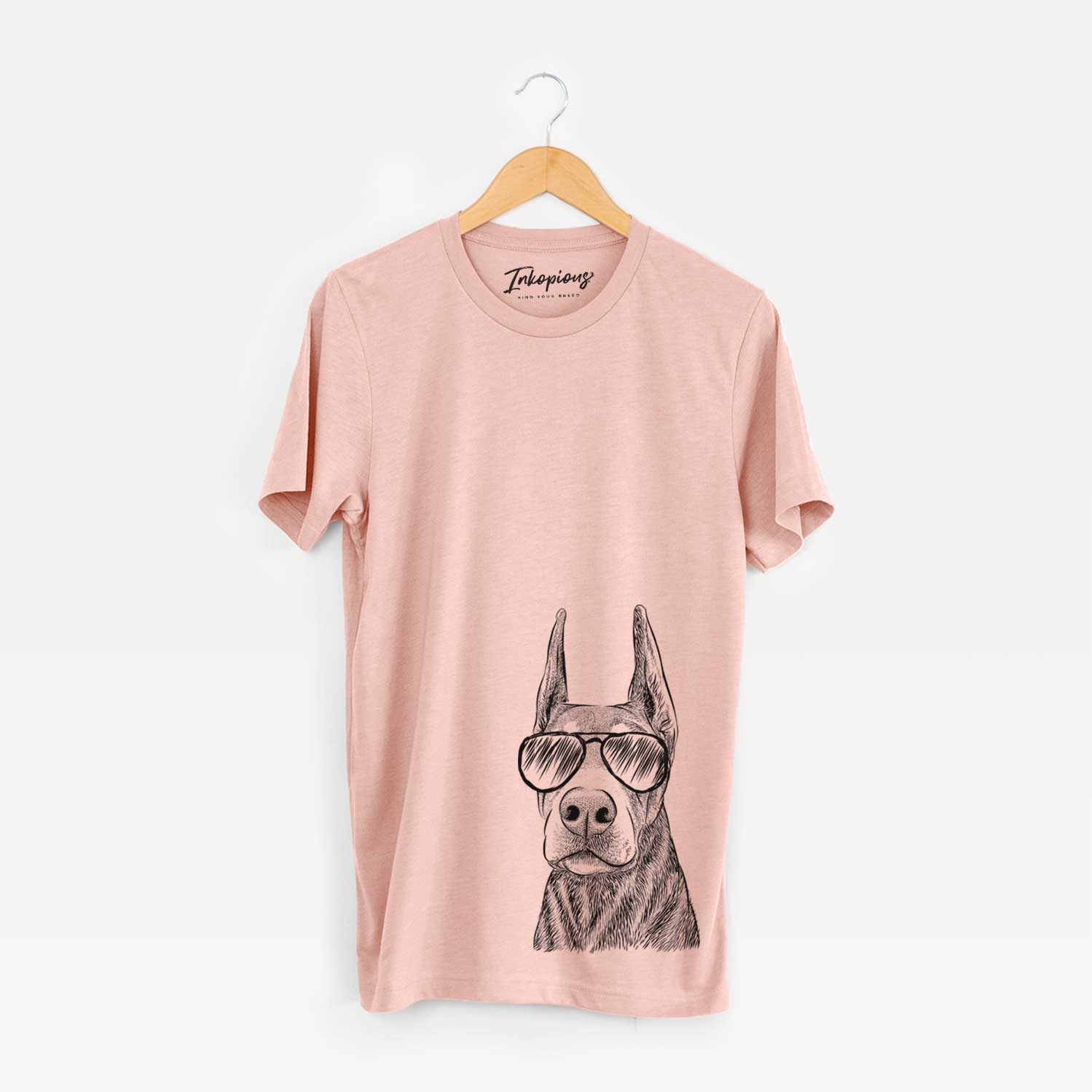 Hand-drawn sketch of Luna the Doberman Pinscher wearing aviator sunglasses on a Peach Bella Canvas Unisex Crewneck