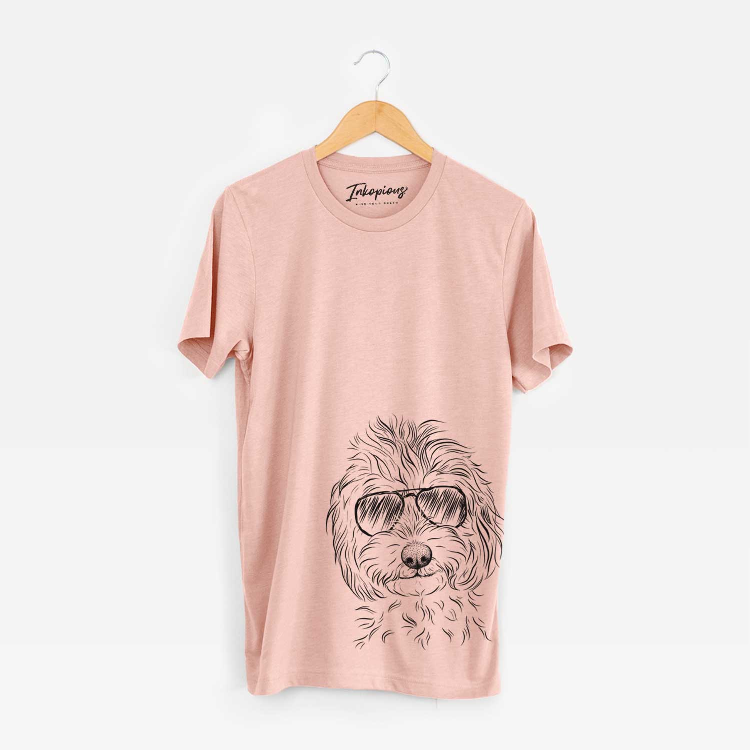 Hand-drawn sketch of Mason the Cavapoo wearing aviator sunglasses on a Peach Unisex crewneck