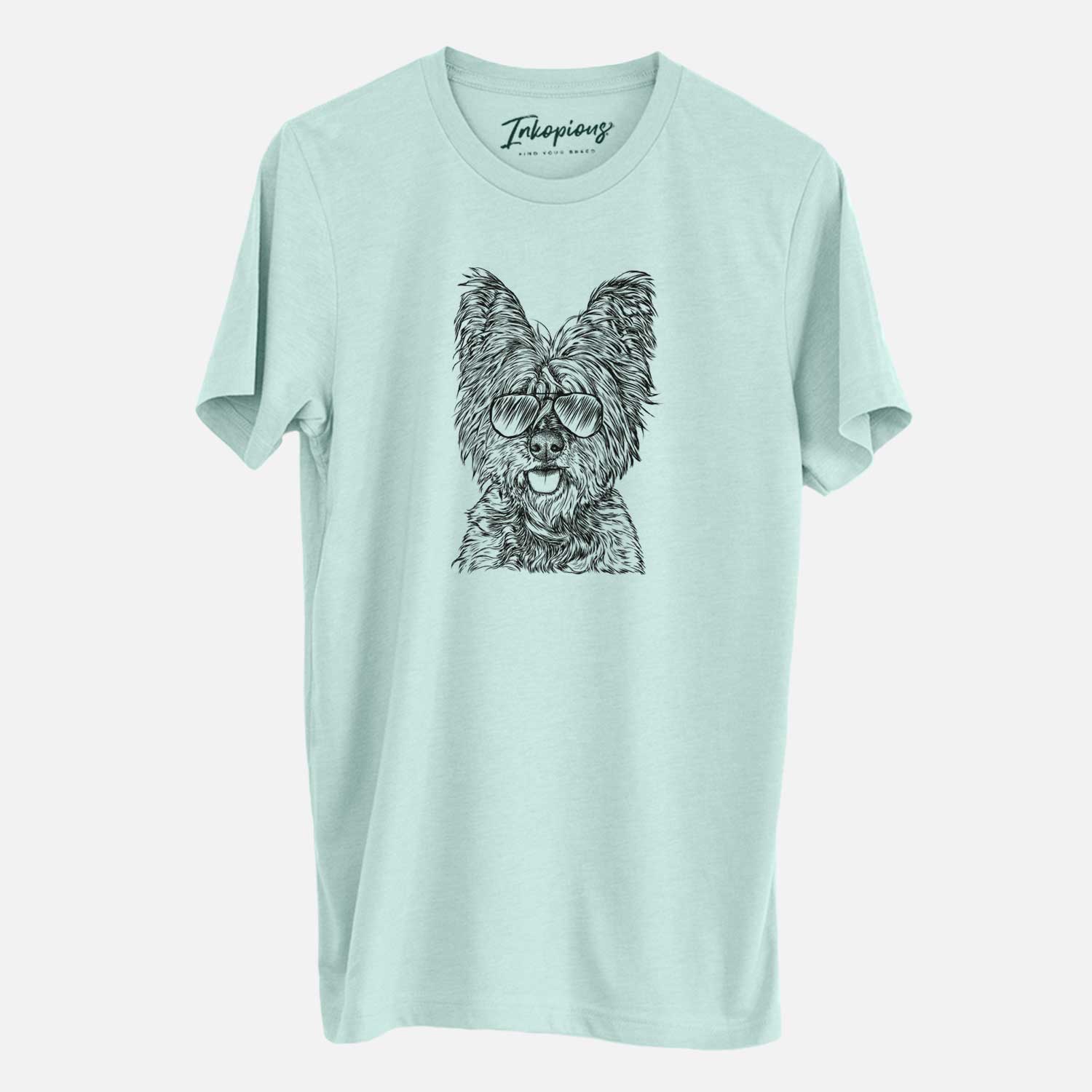 Hand-drawn sketch of McDuff the Cairn Terrier wearing aviator sunglasses on a Heather Sage Unisex crewneck
