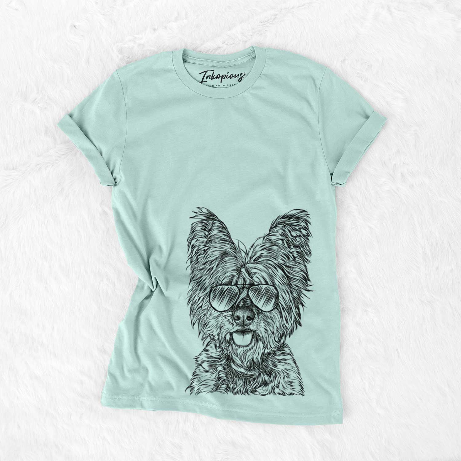 Hand-drawn sketch of McDuff the Cairn Terrier wearing aviator sunglasses on a Heather Sage Unisex crewneck