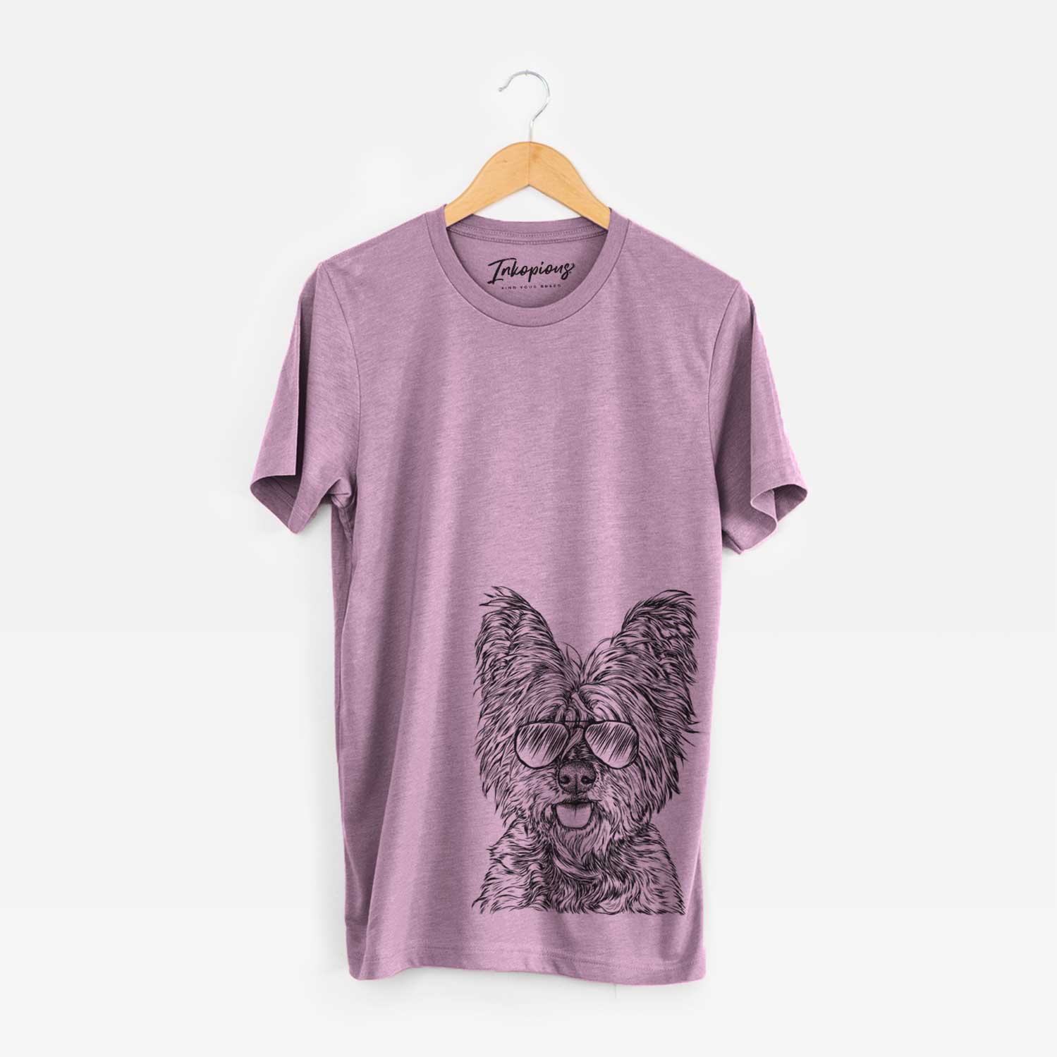 Hand-drawn sketch of McDuff the Cairn Terrier wearing aviator sunglasses on an Orchid Unisex crewneck
