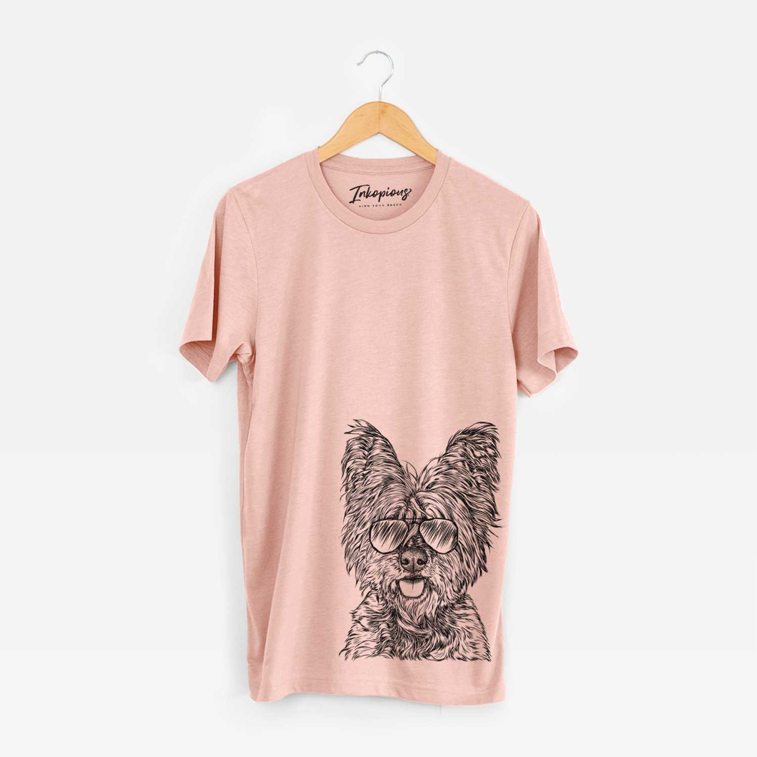 Hand-drawn sketch of McDuff the Cairn Terrier wearing aviator sunglasses on a Peach Bella Canvas Unisex Crewneck