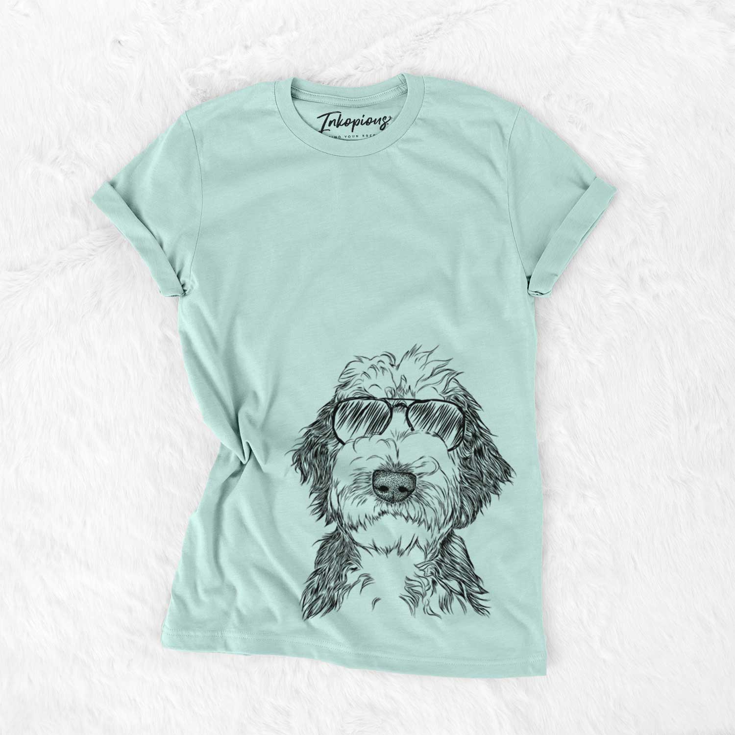 Hand-drawn sketch of Milo Fluff the Sheepadoodle wearing aviator sunglasses on a Heather Sage Unisex crewneck