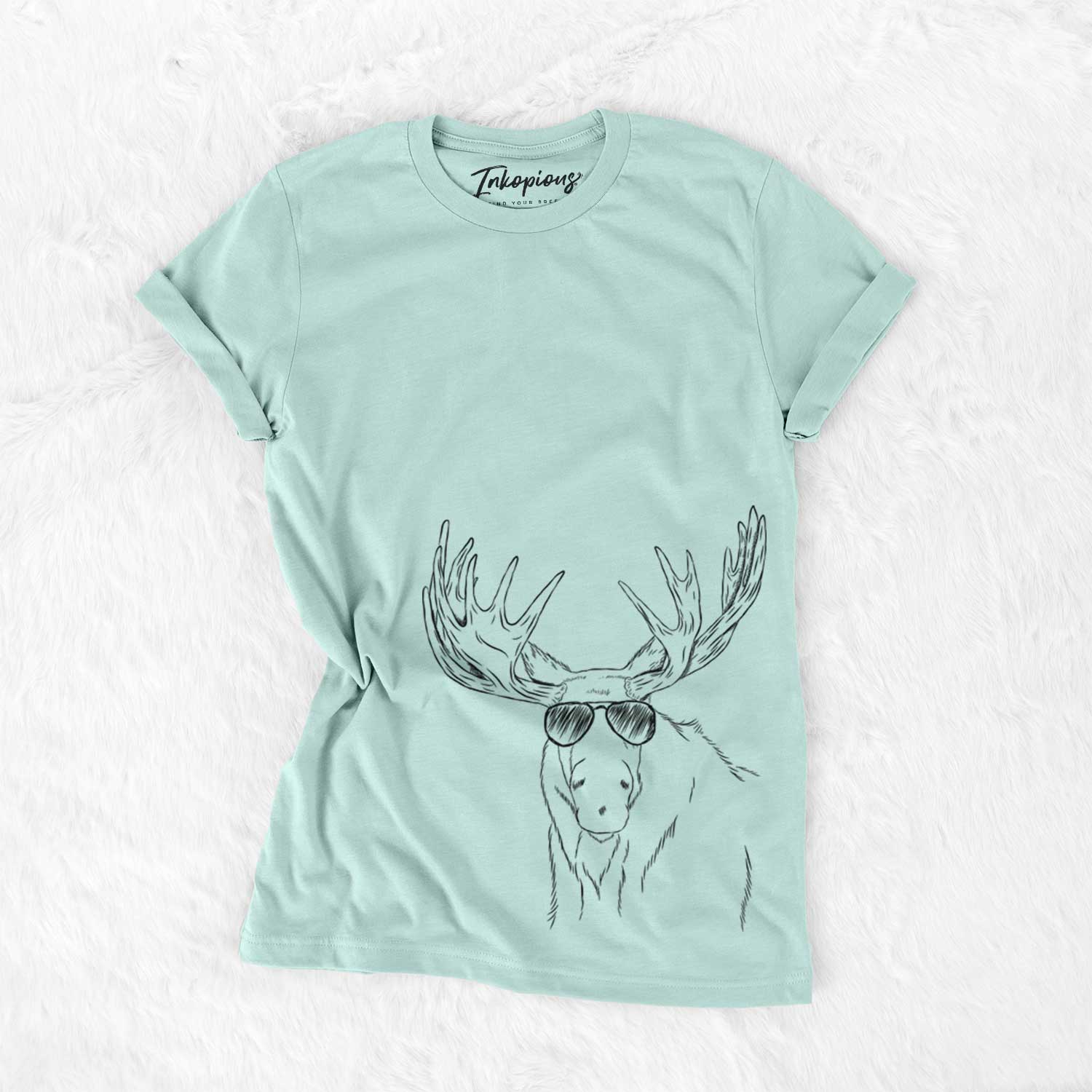 Hand-drawn sketch of Monty the Moose wearing aviator sunglasses on a Heather Sage Unisex crewneck
