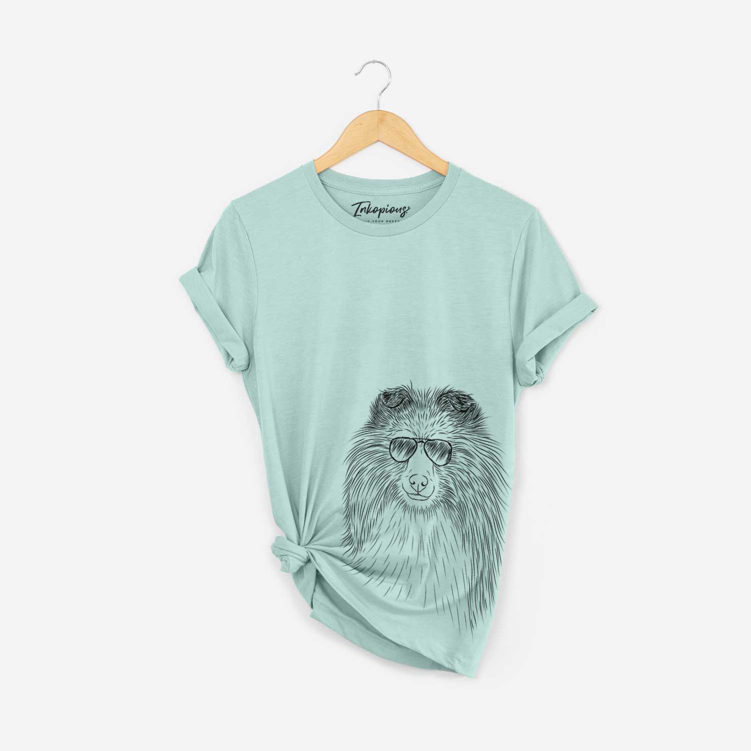 Hand-drawn sketch of Moxie the Shetland Sheepdog wearing aviator sunglasses on a Heather Sage Bella Canvas Unisex Crewneck