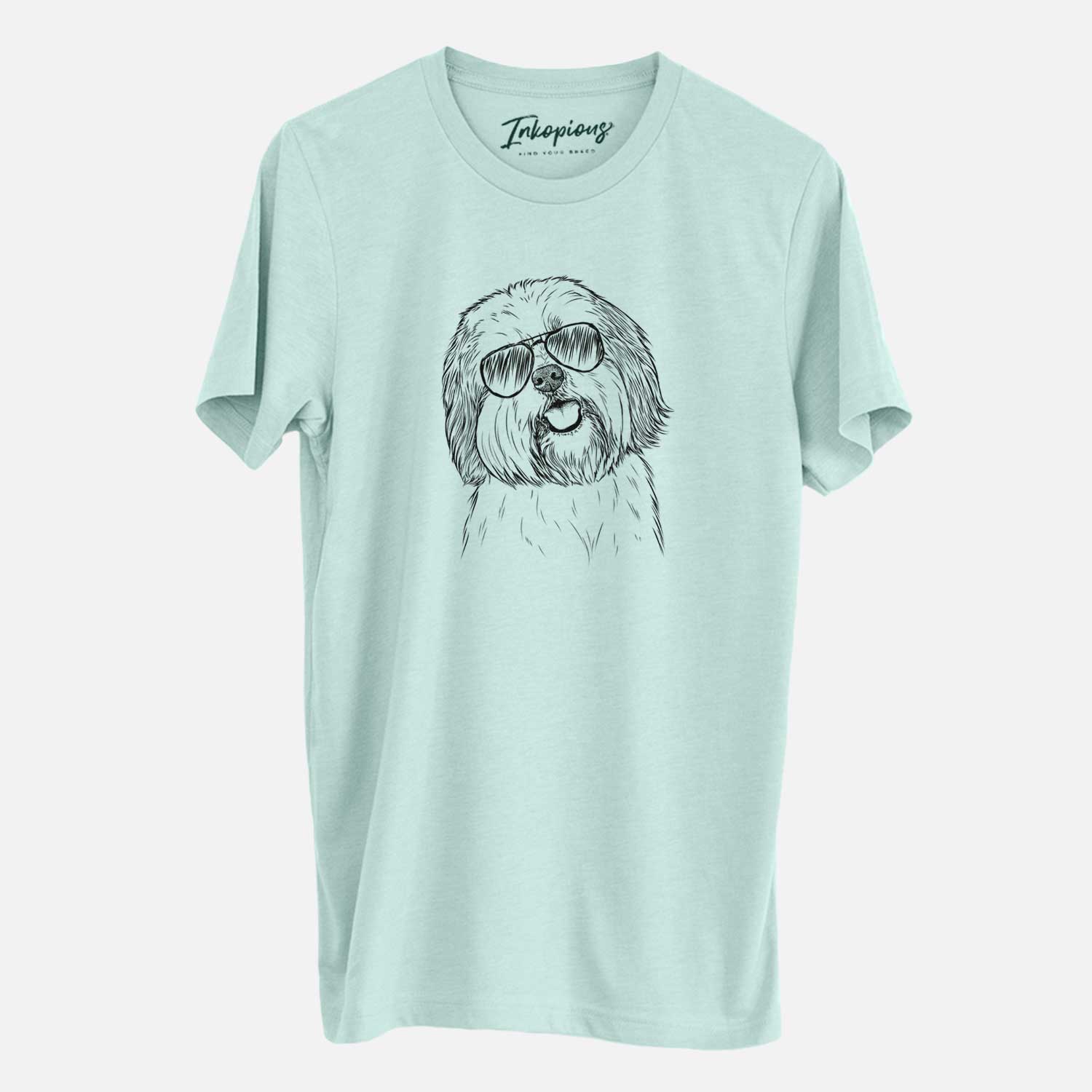 Hand-drawn sketch of Nikka the Lowchen wearing aviator sunglasses on a Heather Sage Unisex crewneck