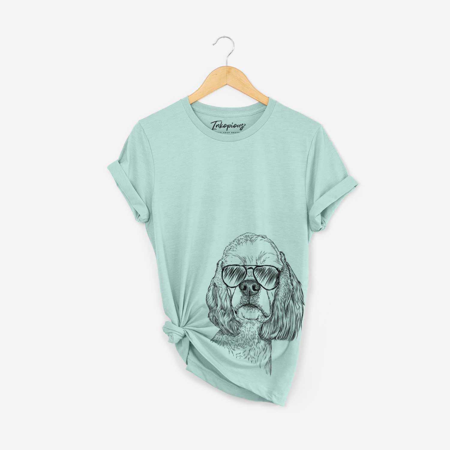 Hand-drawn sketch of Oakley the American Cocker Spaniel wearing aviator sunglasses on a Heather Sage Bella Canvas Unisex Crewneck