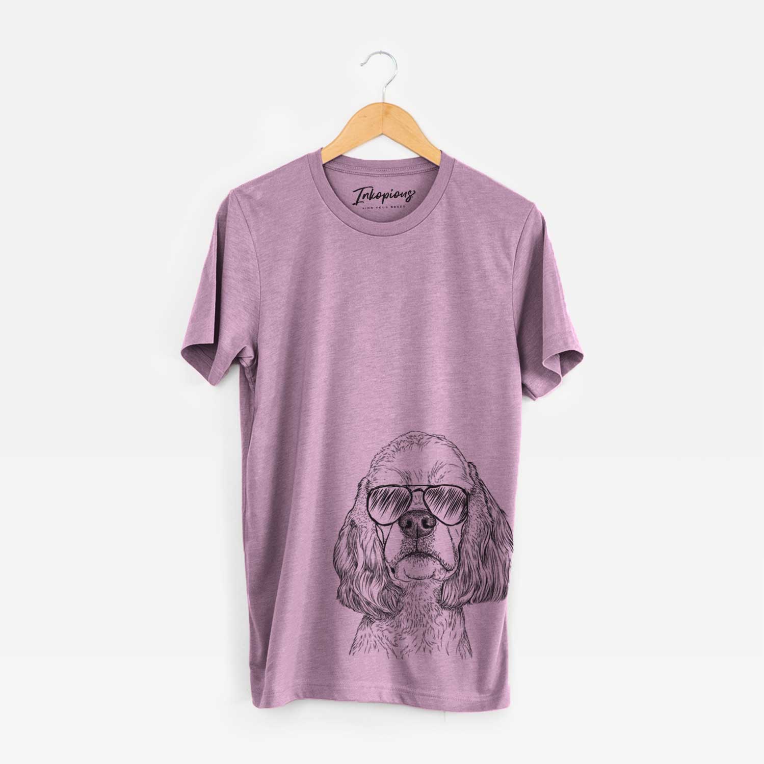 Hand-drawn sketch of Oakley the American Cocker Spaniel wearing aviator sunglasses on an Orchid Bella Canvas Unisex Crewneck