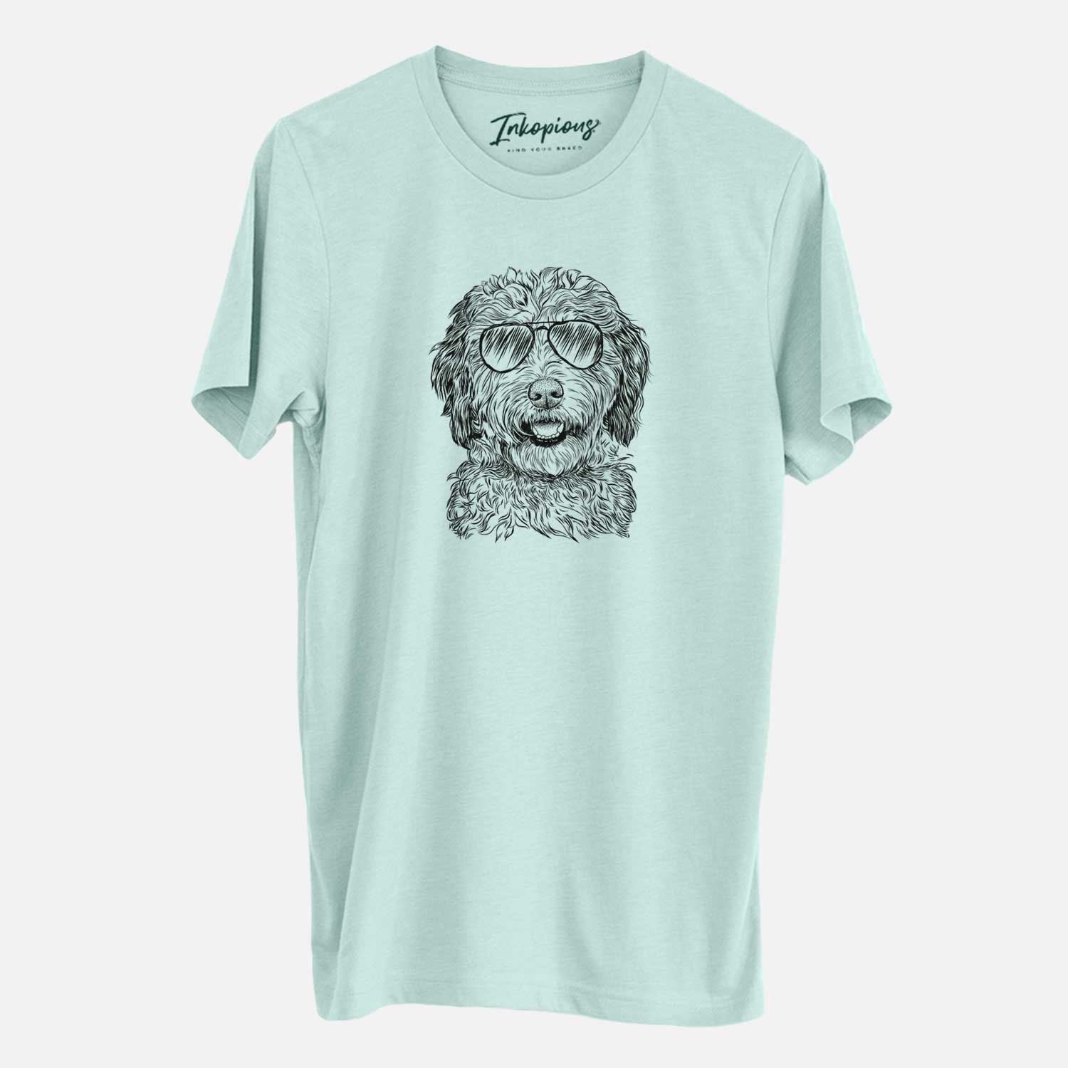 Hand-drawn sketch of Palmer the Aussiedoodle wearing aviator sunglasses on a Heather Sage Unisex crewneck