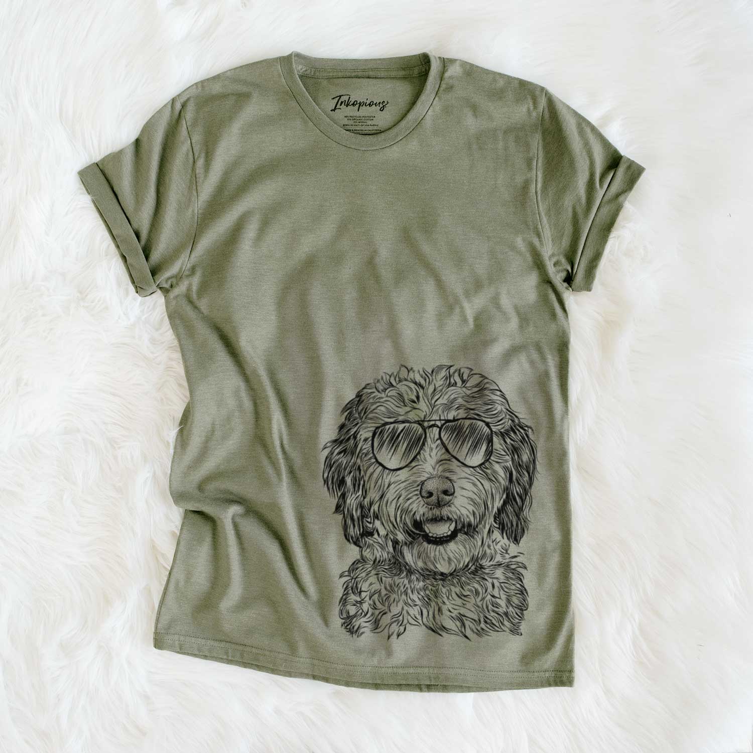 Hand-drawn sketch of Palmer the Aussiedoodle wearing aviator sunglasses on an Olive Unisex crewneck