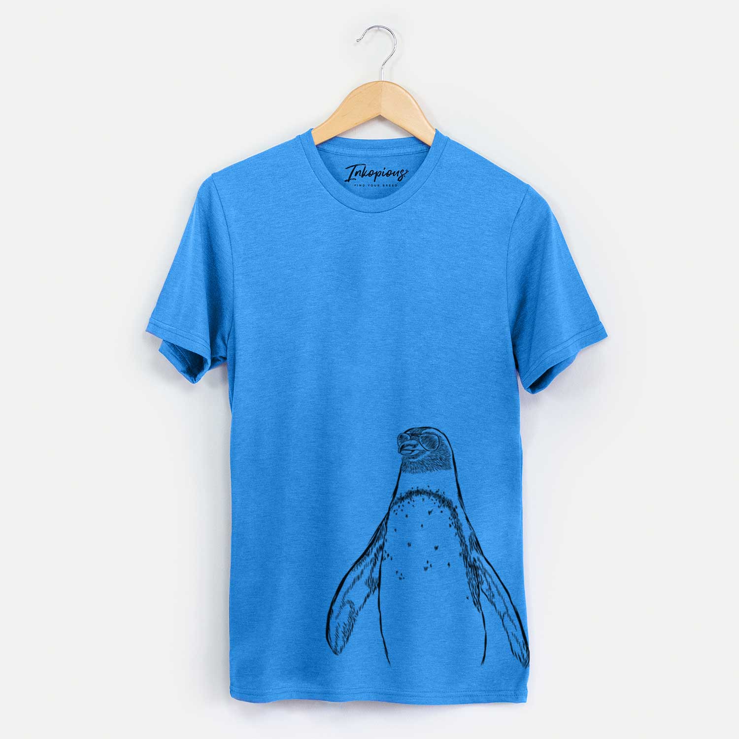 Hand-drawn sketch of Peyton the Penguin wearing aviator sunglasses on a Blue Unisex crewneck