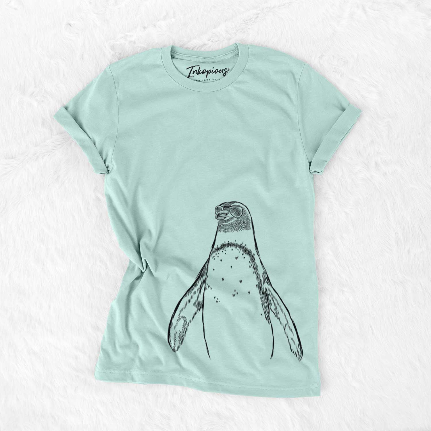 Hand-drawn sketch of Peyton the Penguin wearing aviator sunglasses on a Heather Sage Unisex crewneck