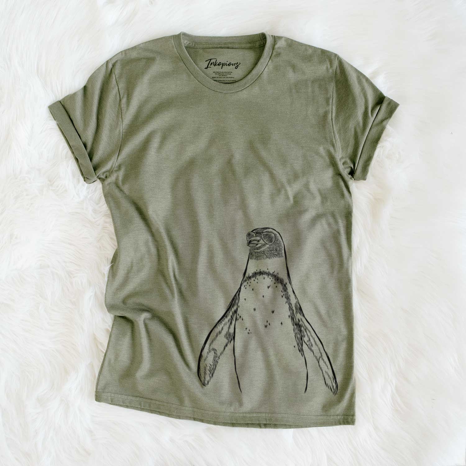 Hand-drawn sketch of Peyton the Penguin wearing aviator sunglasses on an Olive Unisex crewneck