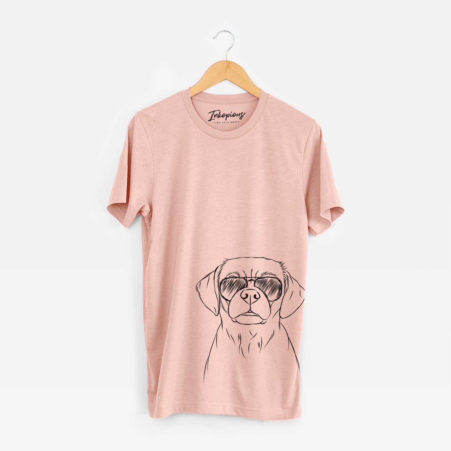 Hand-drawn sketch of Popcorn the Puggle wearing aviator sunglasses on a Peach Unisex crewneck