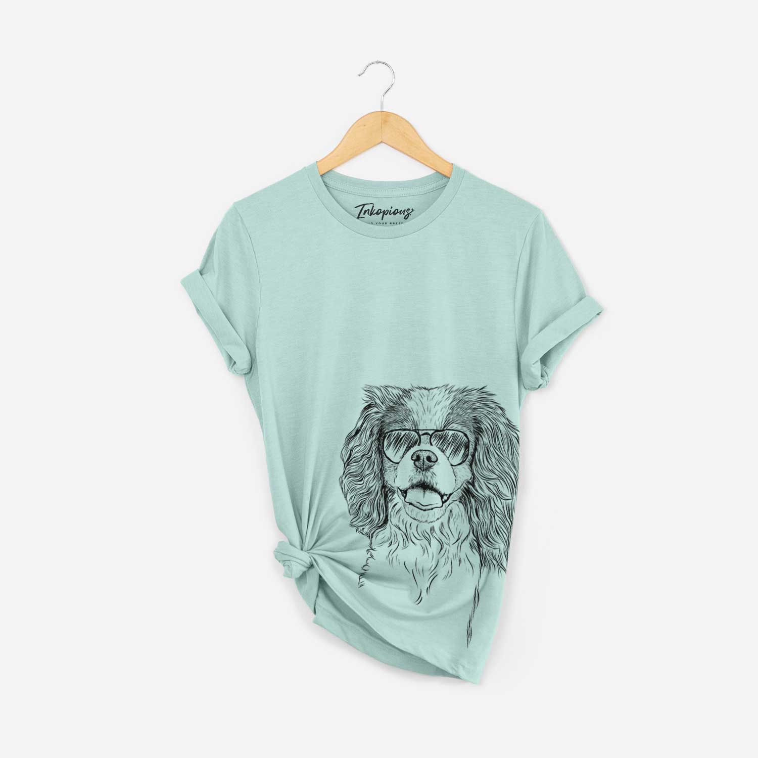 Hand-drawn sketch of Poppy the Cavalier King Charles Spaniel wearing aviator sunglasses on a Heather Sage Bella Canvas Unisex Crewneck
