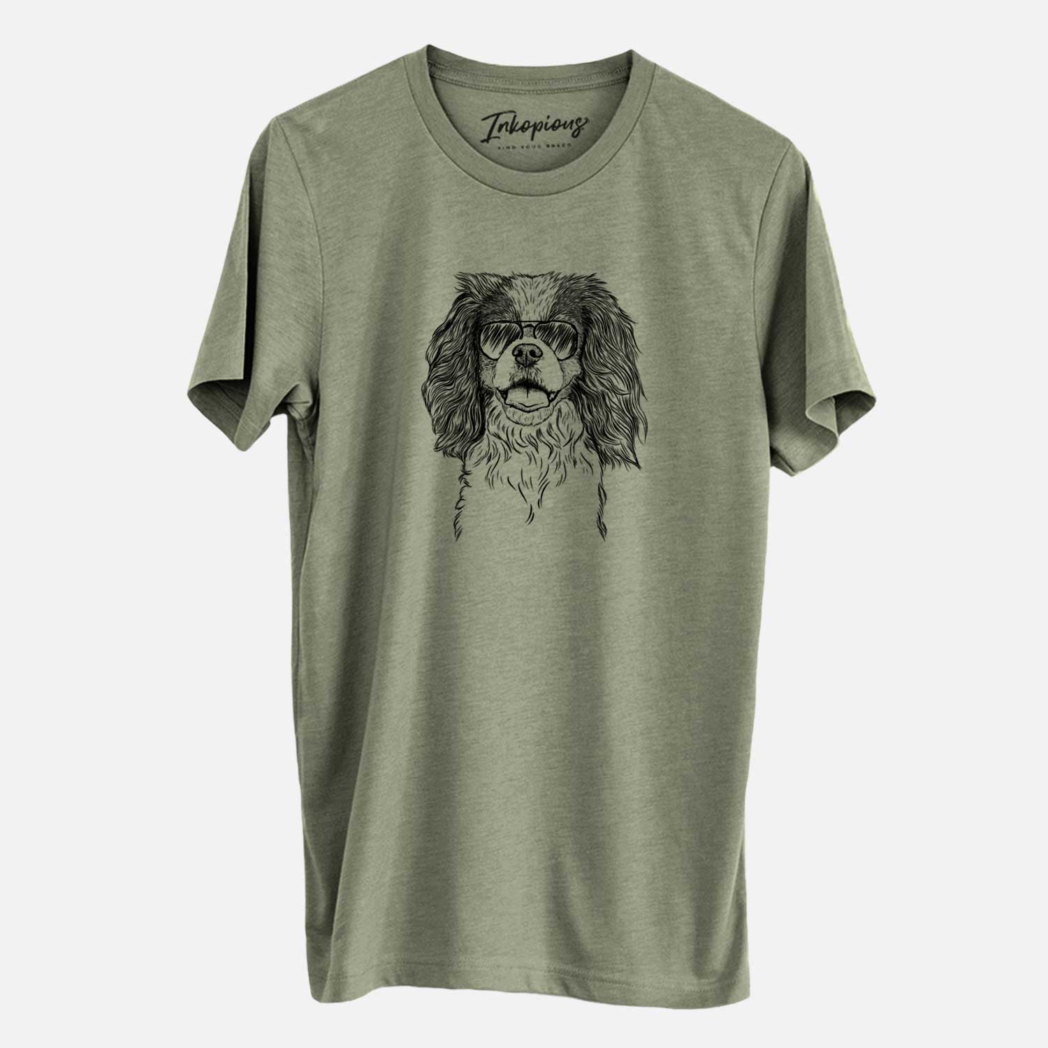Hand-drawn sketch of Poppy the Cavalier King Charles Spaniel wearing aviator sunglasses on an Olive Unisex crewneck