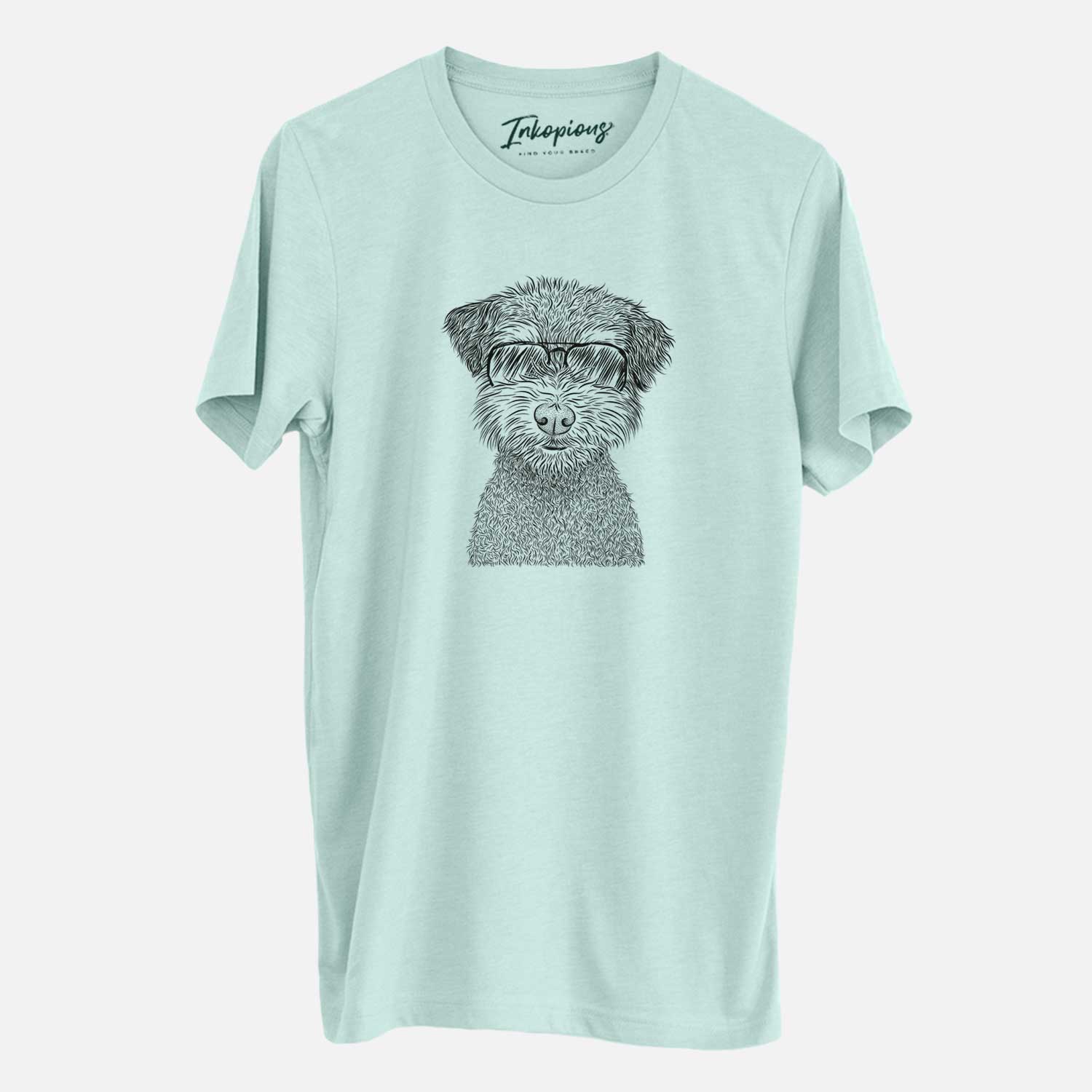 Hand-drawn sketch of Pretzel the Schnoodle wearing aviator sunglasses on a Heather Sage Unisex crewneck