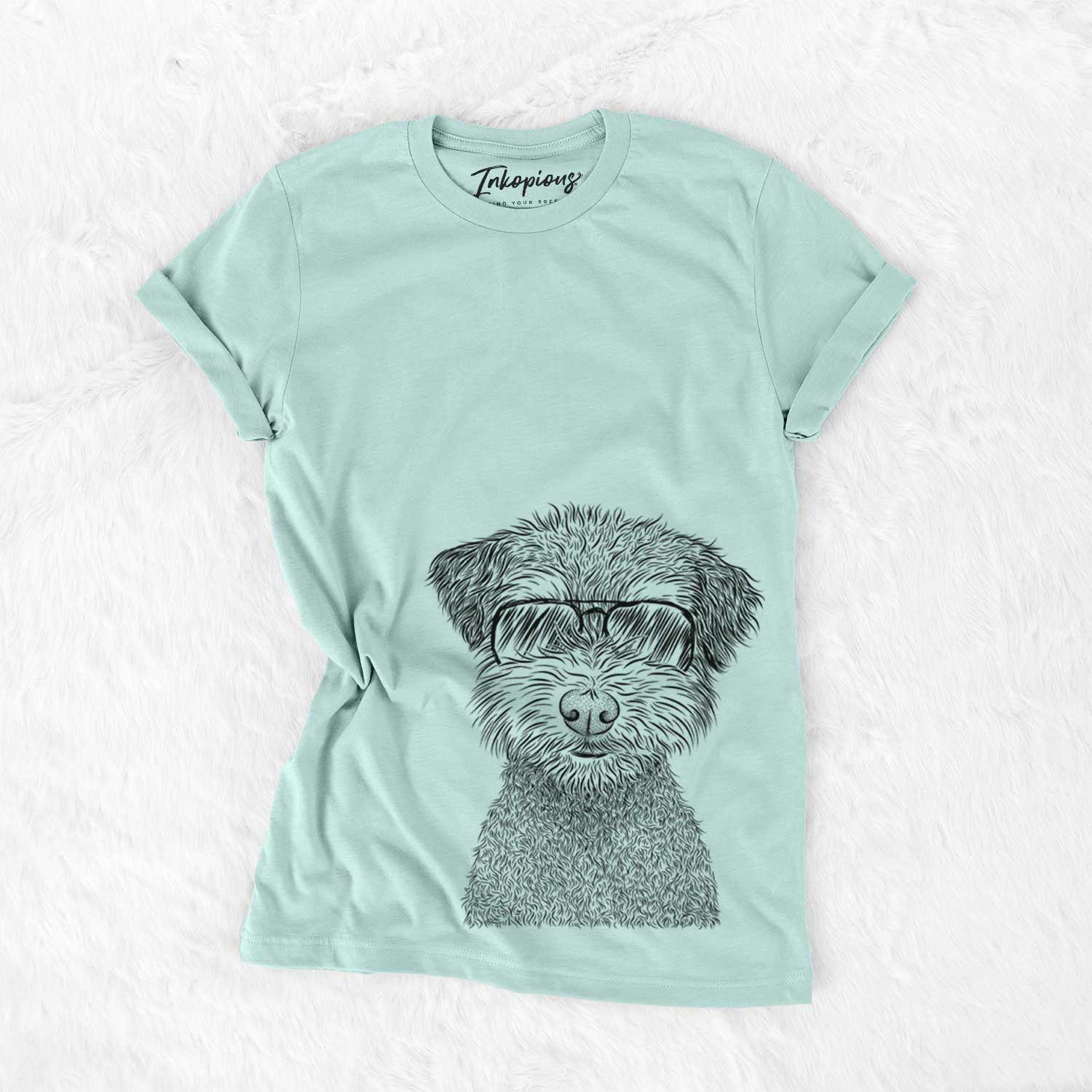 Hand-drawn sketch of Pretzel the Schnoodle wearing aviator sunglasses on a Heather Sage Unisex crewneck