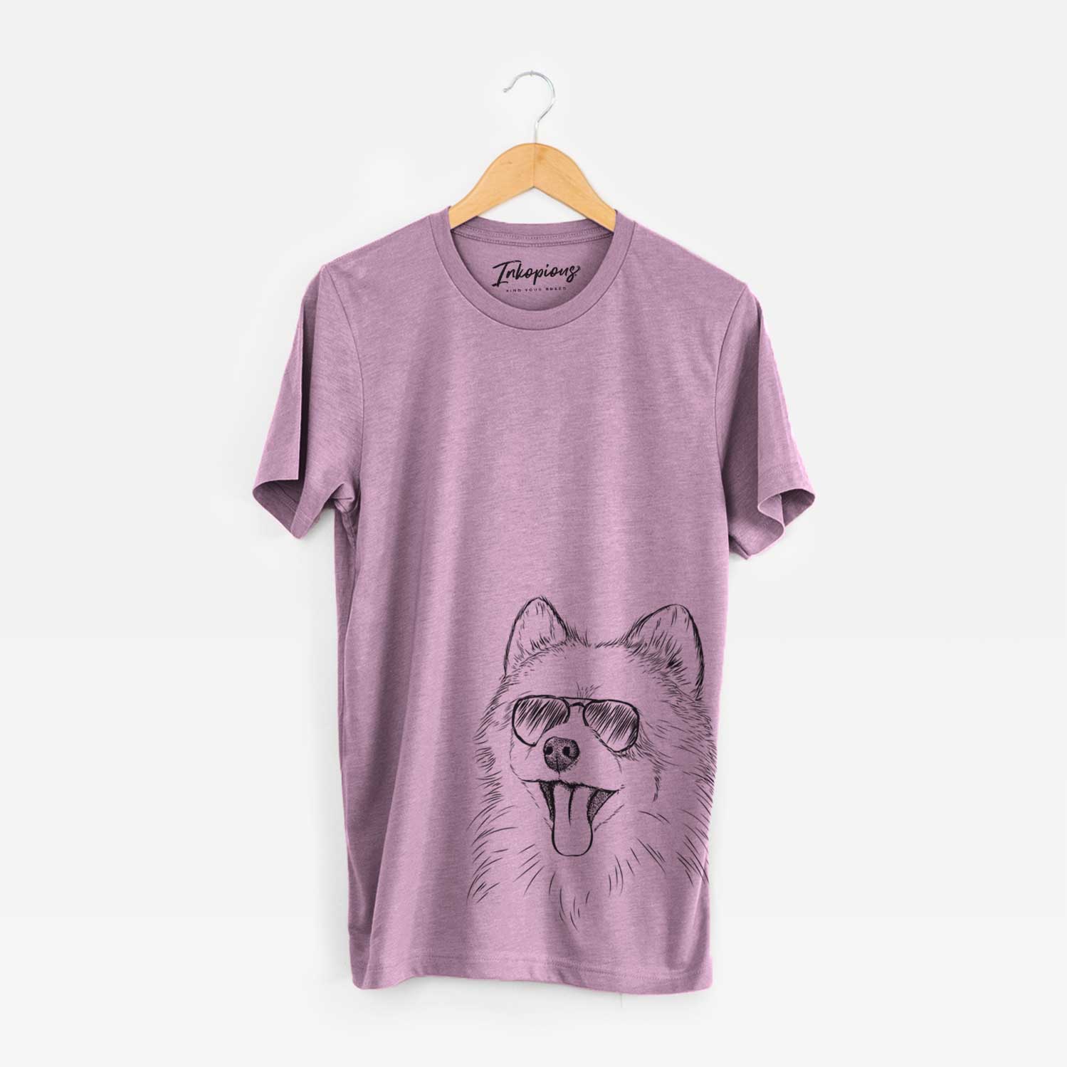 Hand-drawn sketch of Quinn the Pomeranian wearing aviator sunglasses on an Orchid Unisex crewneck