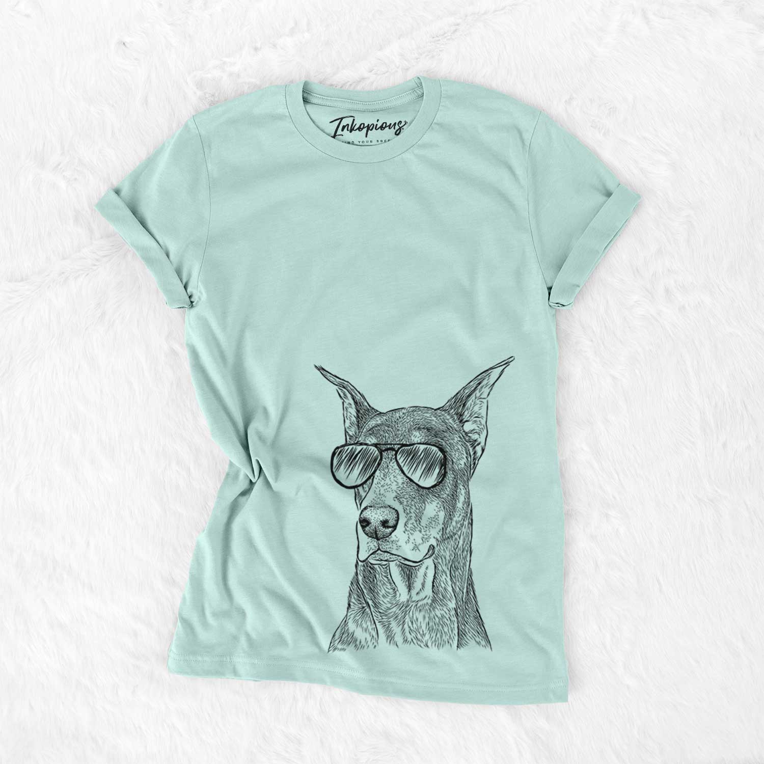 Hand-drawn sketch of RJ the Doberman Pinscher wearing aviator sunglasses on a Heather Sage Unisex crewneck