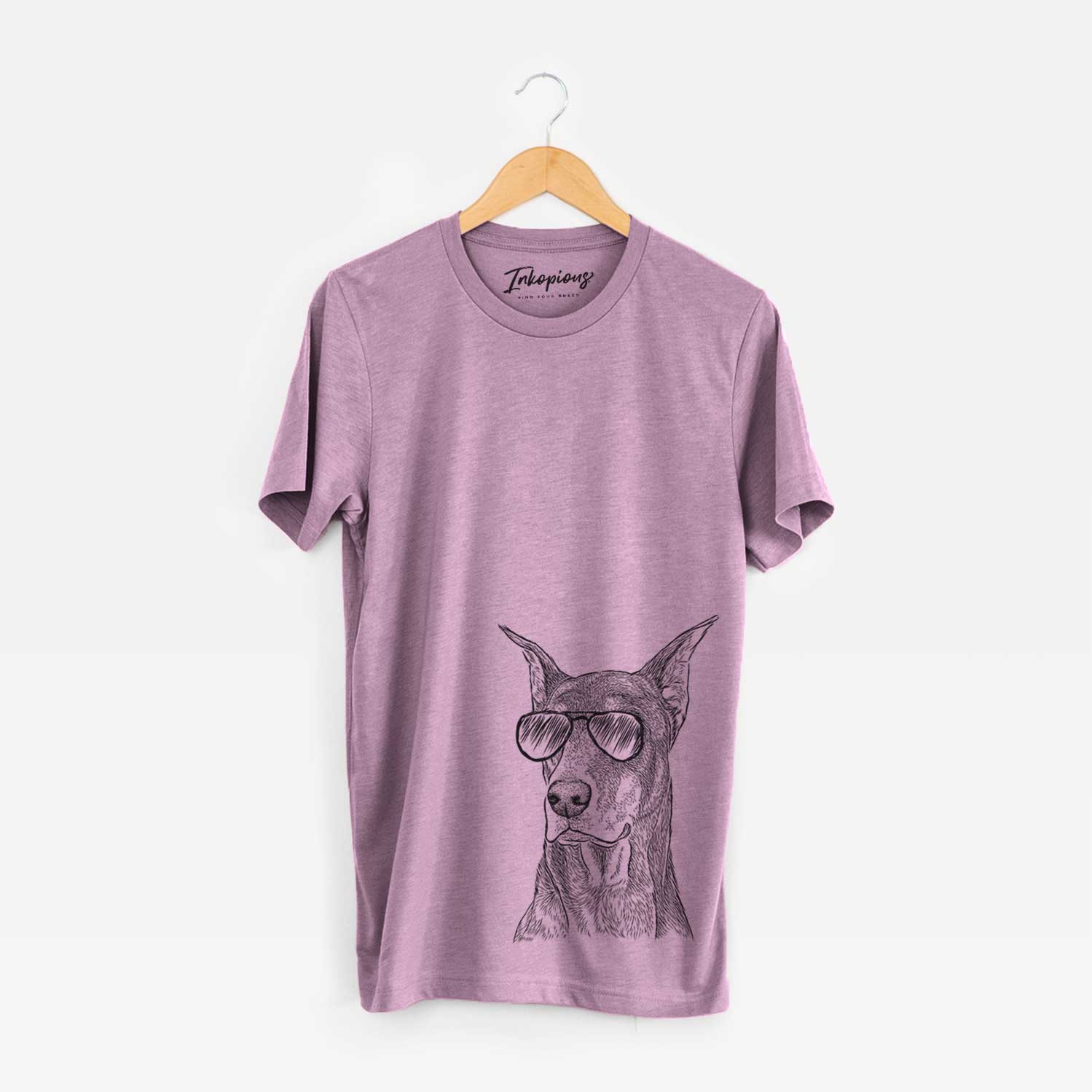 Hand-drawn sketch of RJ the Doberman Pinscher wearing aviator sunglasses on an Orchid Unisex crewneck