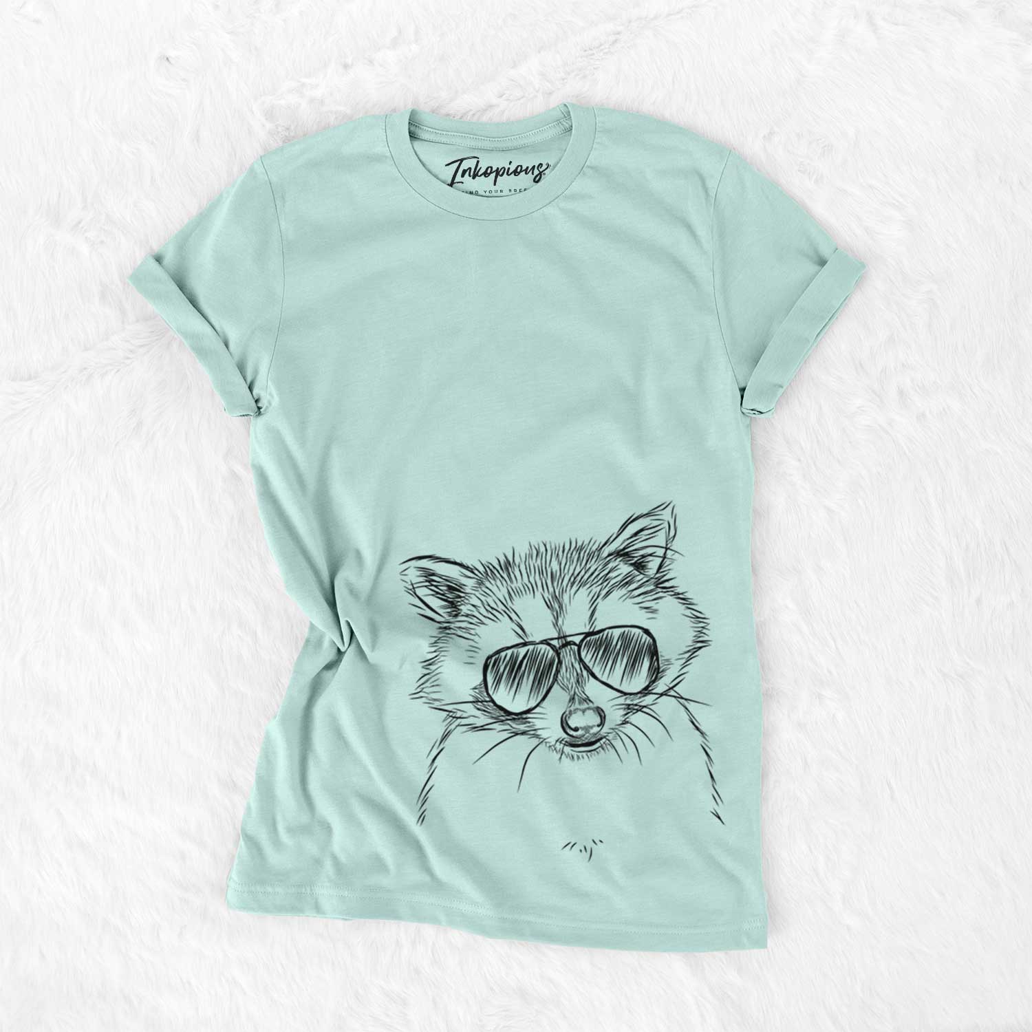 Hand-drawn sketch of Randy the Raccoon wearing aviator sunglasses on a Heather Sage Unisex crewneck