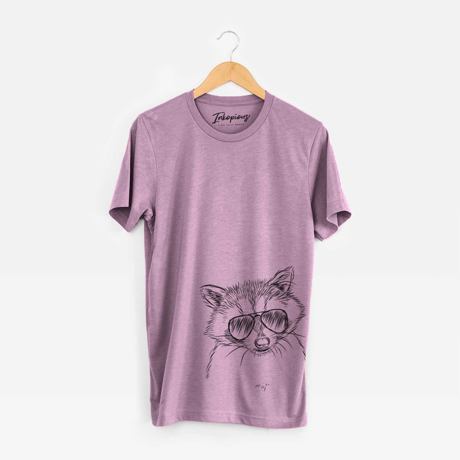 Hand-drawn sketch of Randy the Raccoon wearing aviator sunglasses on an Orchid Unisex crewneck