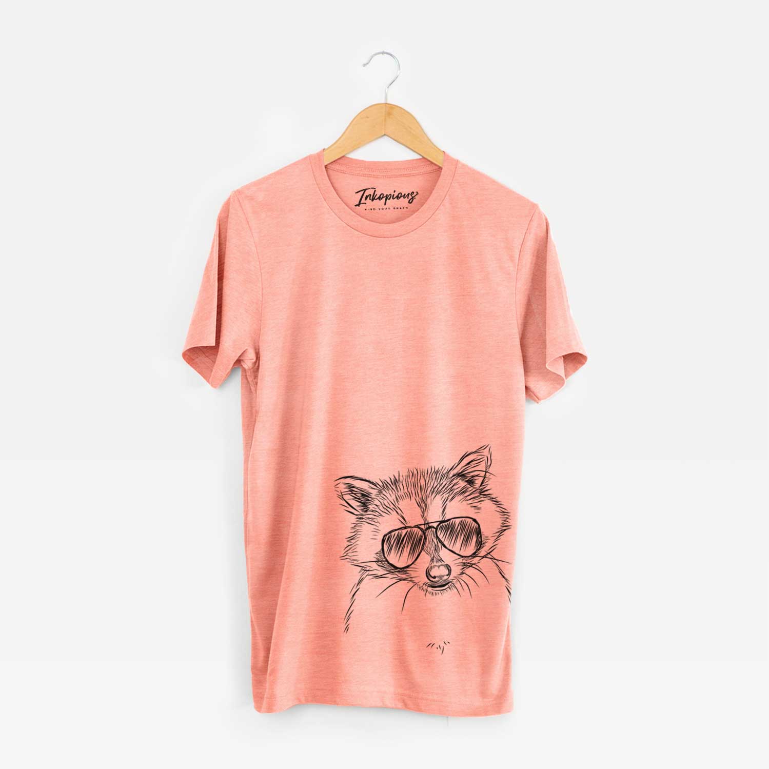 Hand-drawn sketch of Randy the Raccoon wearing aviator sunglasses on a Sunset Unisex crewneck