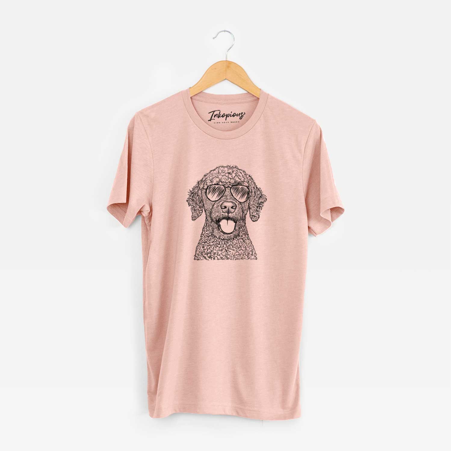 Hand-drawn sketch of Reina the Spanish Water Dog wearing aviator sunglasses on a Peach Unisex crewneck