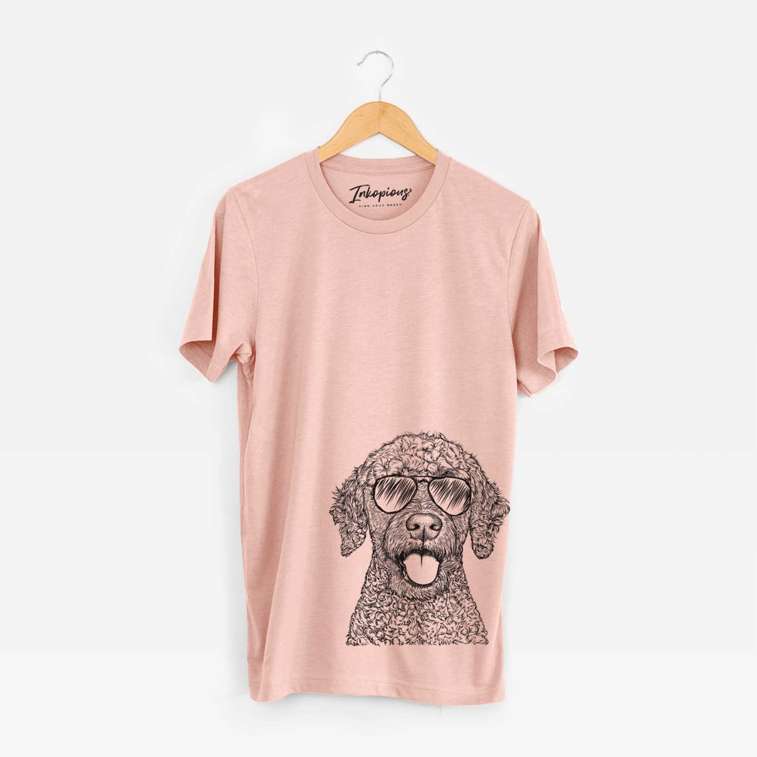 Hand-drawn sketch of Reina the Spanish Water Dog wearing aviator sunglasses on a Peach Unisex crewneck