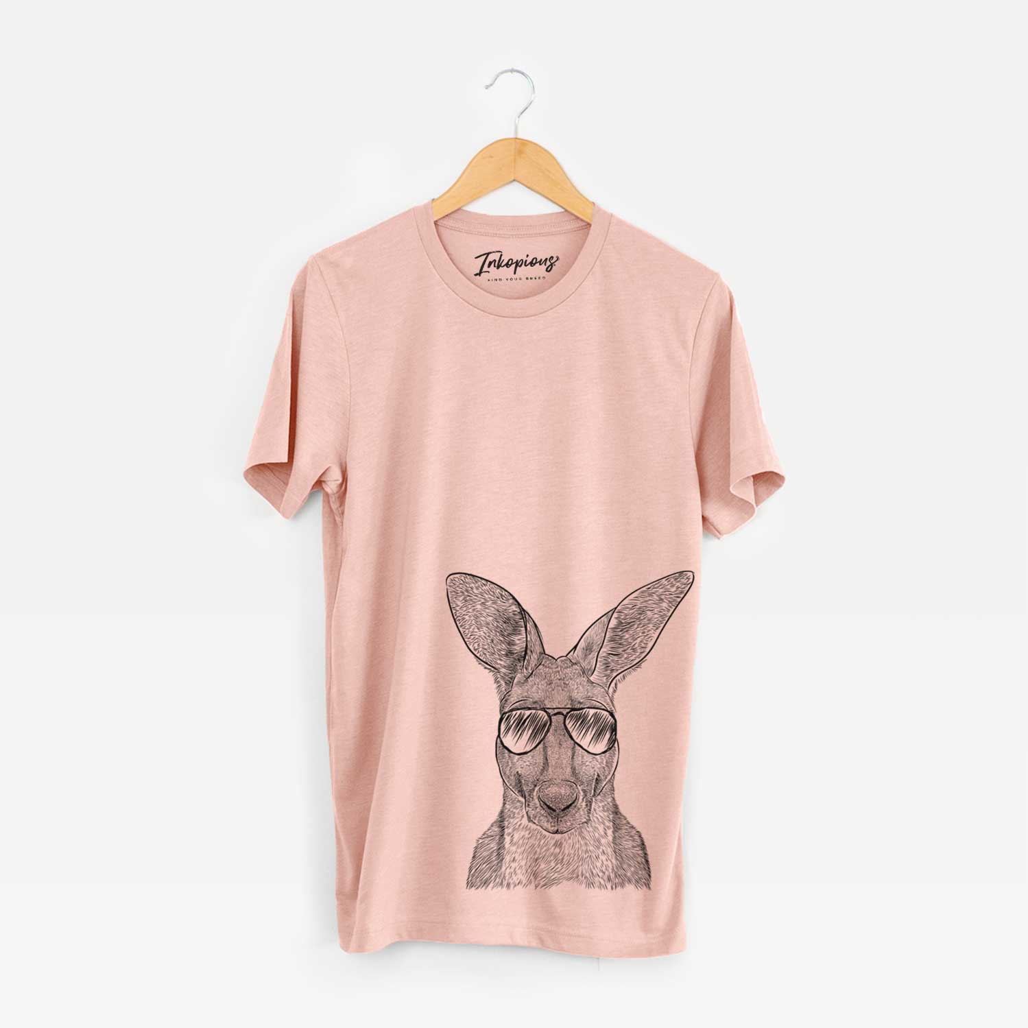 Hand-drawn sketch of Roger the Red Kangaroo wearing aviator sunglasses on a Peach Unisex crewneck