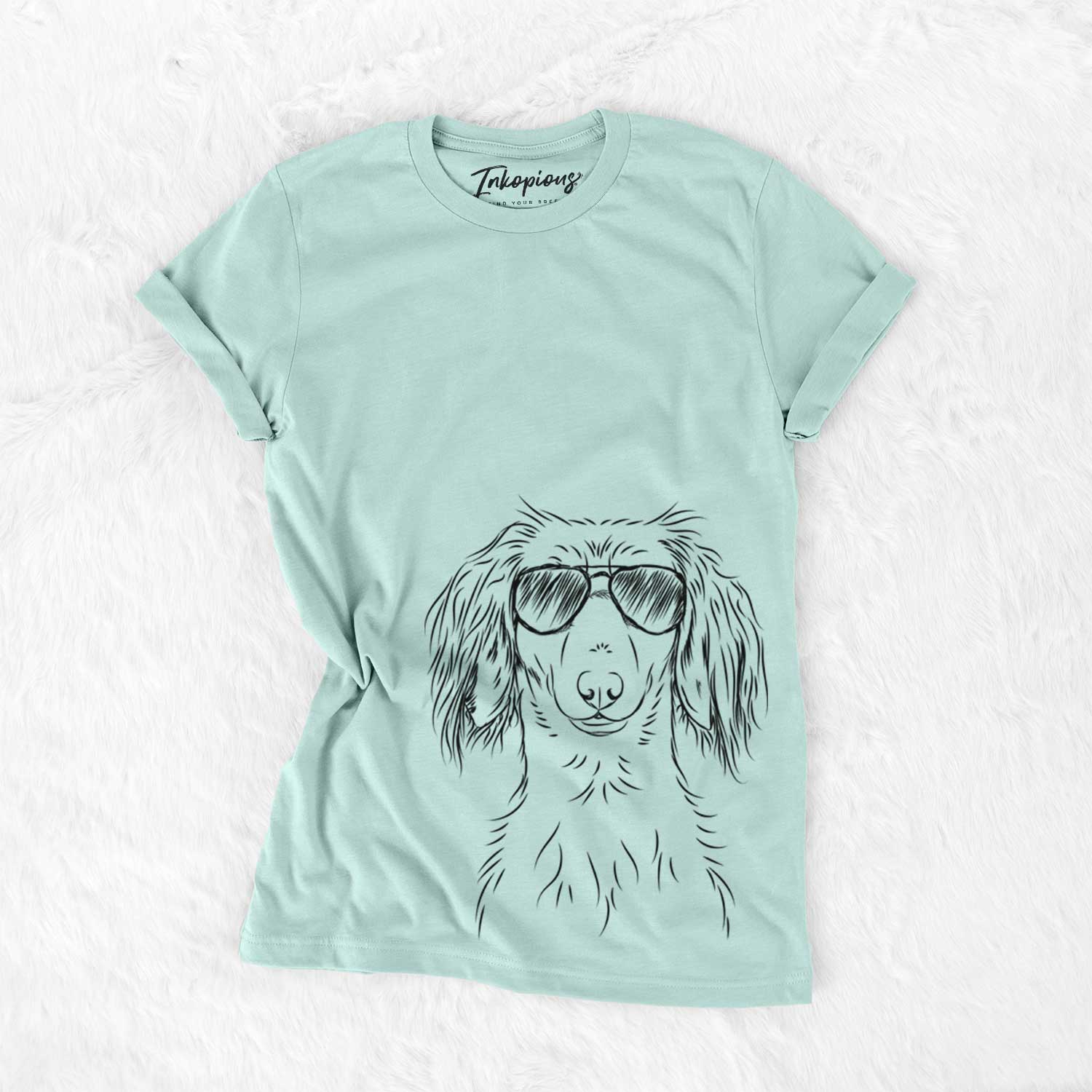 Hand-drawn sketch of Roux the Long Haired Dachshund wearing aviator sunglasses on a Heather Sage Unisex crewneck