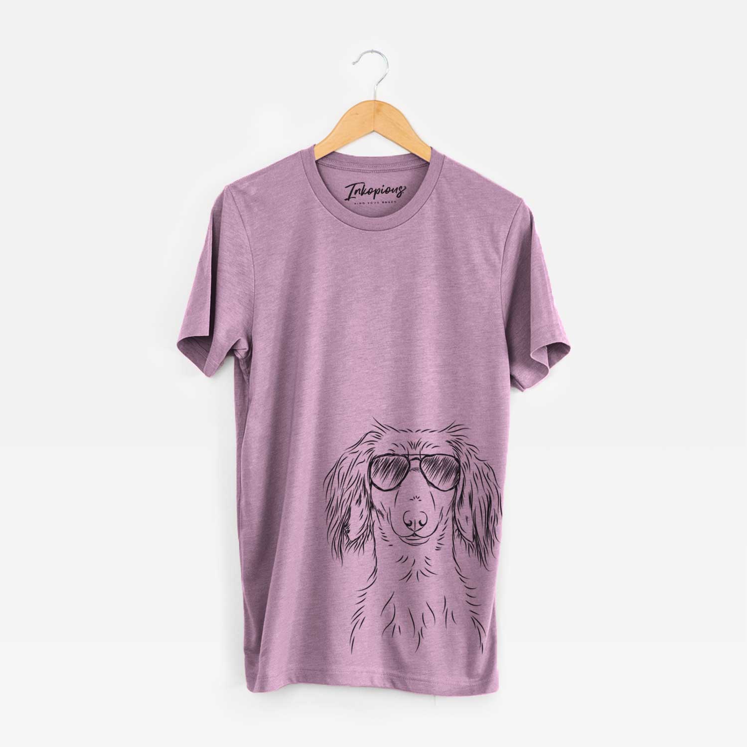 Hand-drawn sketch of Roux the Long Haired Dachshund wearing aviator sunglasses on an Orchid Unisex crewneck