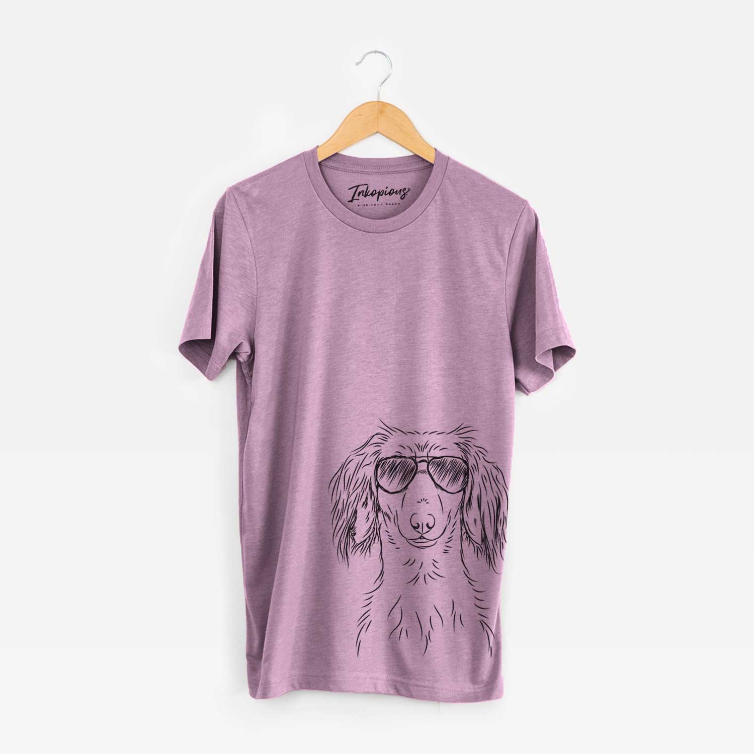 Hand-drawn sketch of Roux the Long Haired Dachshund wearing aviator sunglasses on an Orchid Bella Canvas Unisex Crewneck