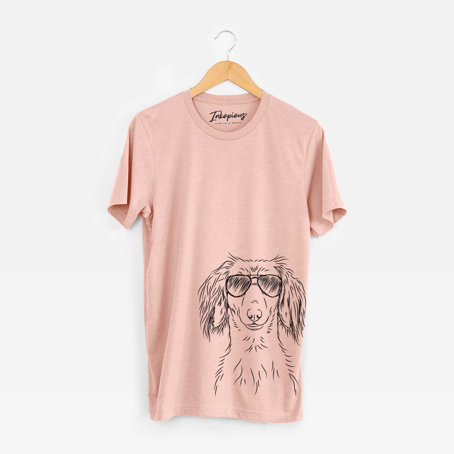 Hand-drawn sketch of Roux the Long Haired Dachshund wearing aviator sunglasses on a Peach Bella Canvas Unisex Crewneck