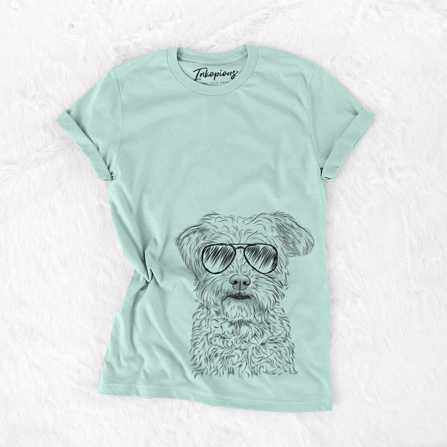 Hand-drawn sketch of Rudy the Schnoodle wearing aviator sunglasses on a Heather Sage Unisex crewneck