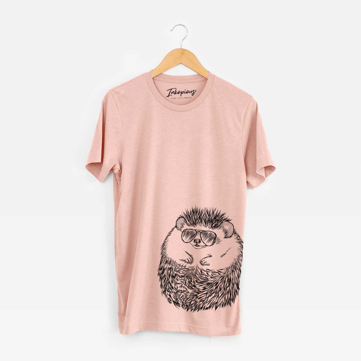 Hand-drawn sketch of Sid the Hedgehog wearing aviator sunglasses on a Peach Bella Canvas Unisex Crewneck