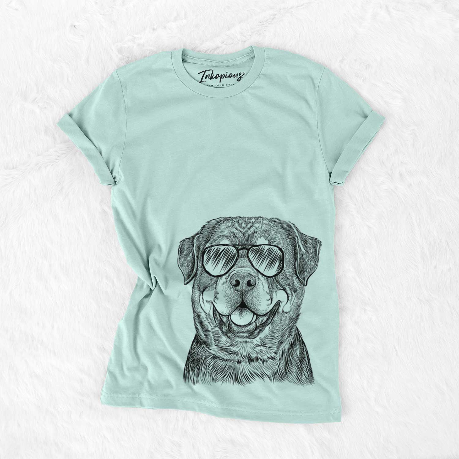 Hand-drawn sketch of Sig the Rottweiler wearing aviator sunglasses on a Heather Sage Unisex crewneck