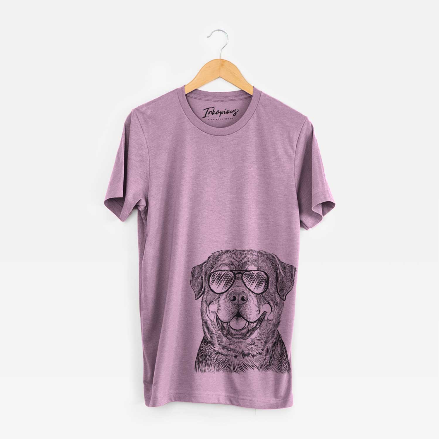 Hand-drawn sketch of Sig the Rottweiler wearing aviator sunglasses on an Orchid Unisex crewneck