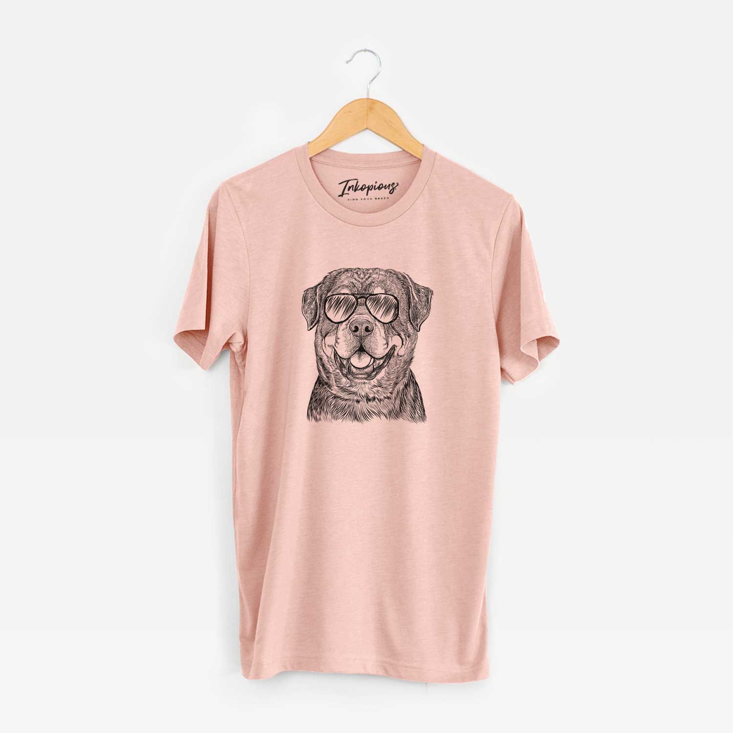 Hand-drawn sketch of Sig the Rottweiler wearing aviator sunglasses on a Peach Unisex crewneck