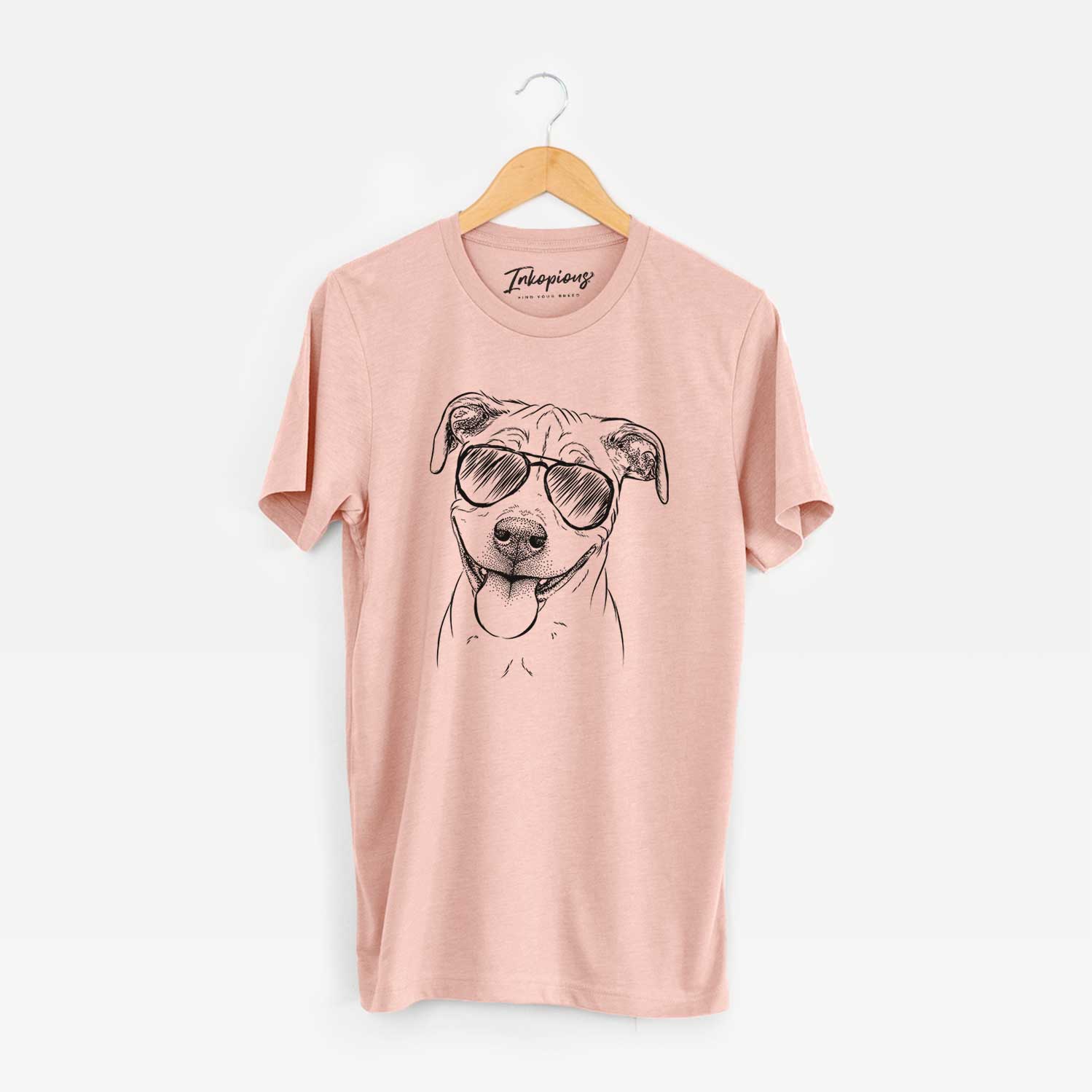 Hand-drawn sketch of Skye the Pitweiler wearing aviator sunglasses on a Peach Unisex crewneck