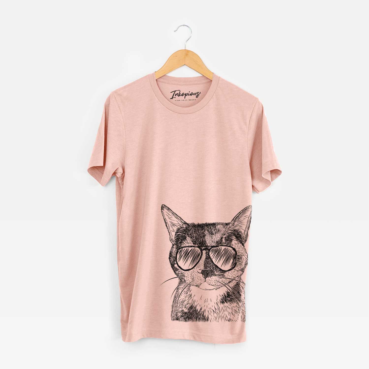 Hand-drawn sketch of Spooky Kitty the Tortoiseshell Cat wearing aviator sunglasses on a Peach Bella Canvas Unisex Crewneck