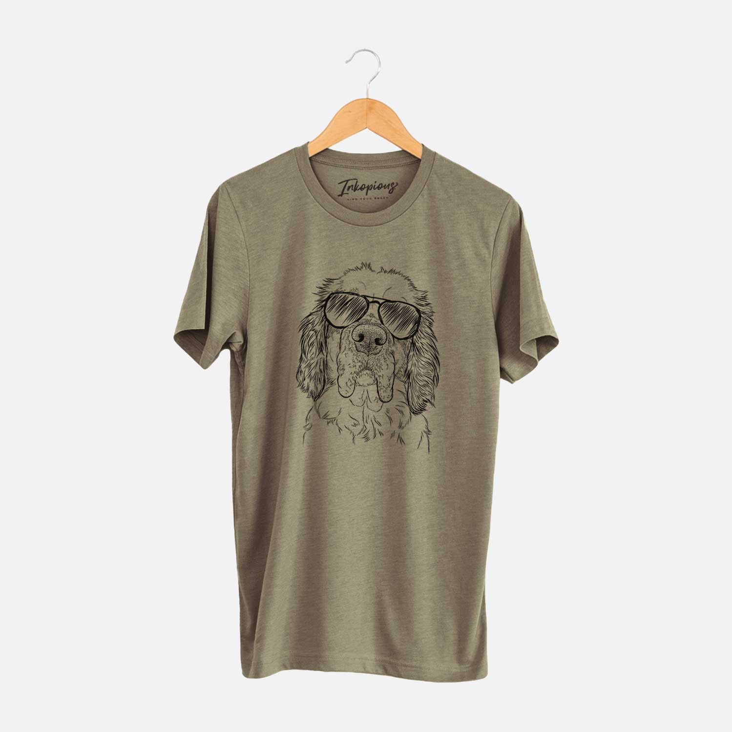 Hand-drawn sketch of Sully the Clumber Spaniel wearing aviator sunglasses on an Olive Unisex crewneck