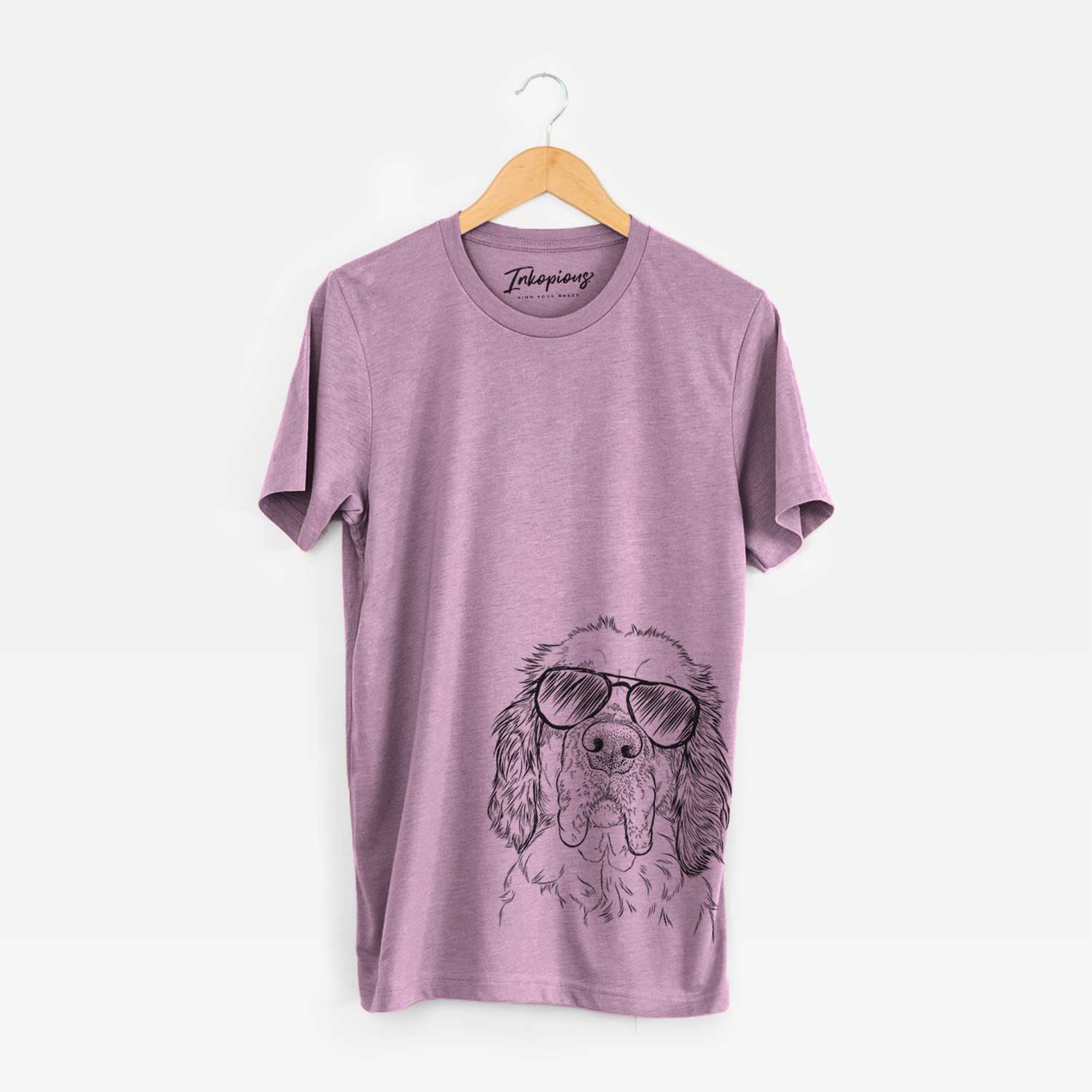 Hand-drawn sketch of Sully the Clumber Spaniel wearing aviator sunglasses on an Orchid Unisex crewneck